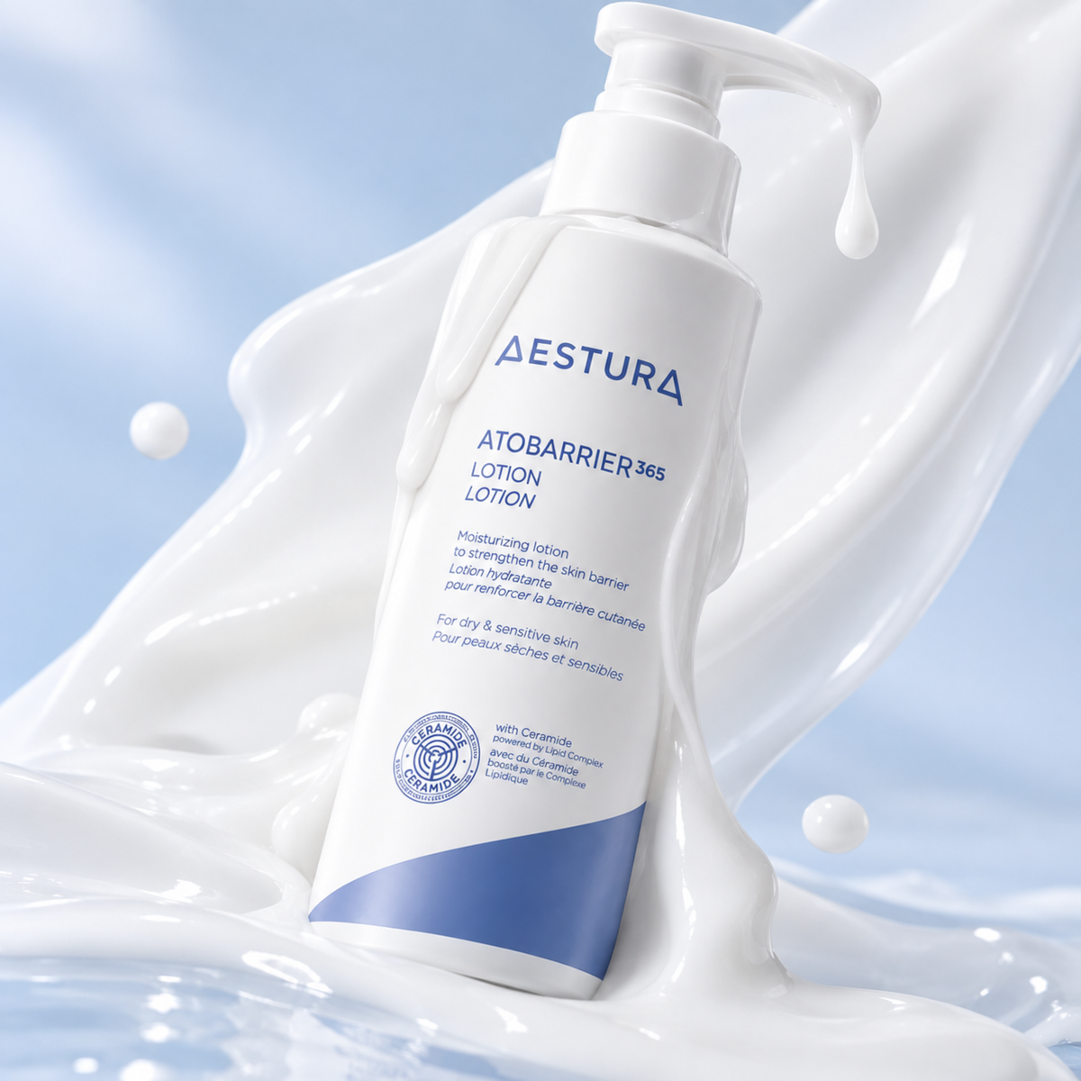 Aestura AtobARRIER 365 Lotion in a white pump bottle with blue text and a blue accent band, set against a stylized background of white liquid splash and light blue water droplets.