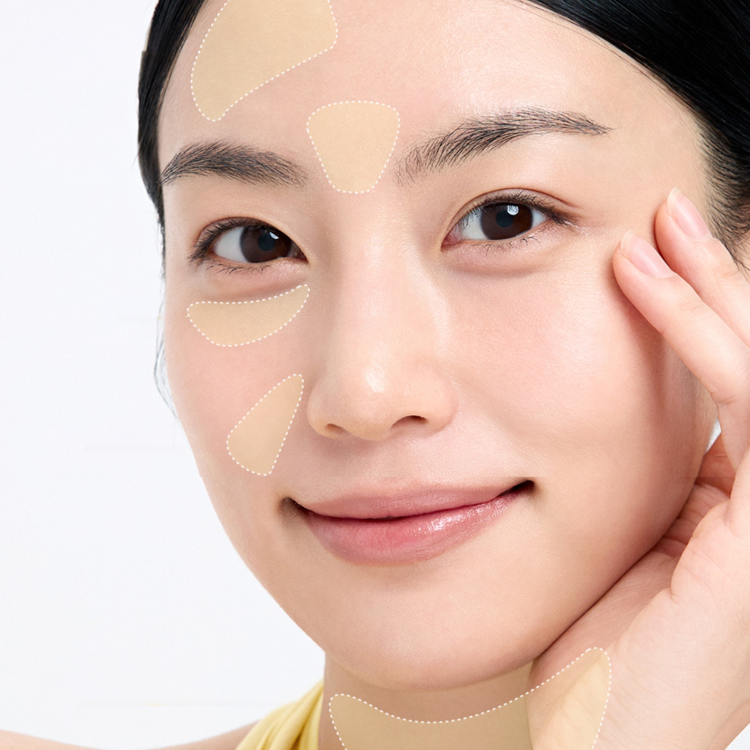 Woman applying beige patches under her eyes on a light background