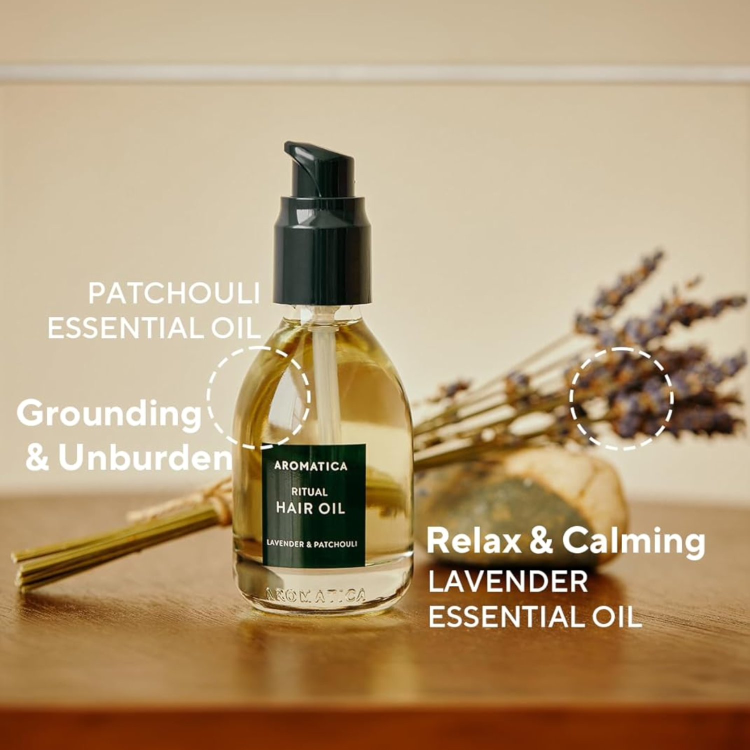Aromatica Ritual Hair Oil bottle with lavender and patchouli essential oils on a wooden surface.
