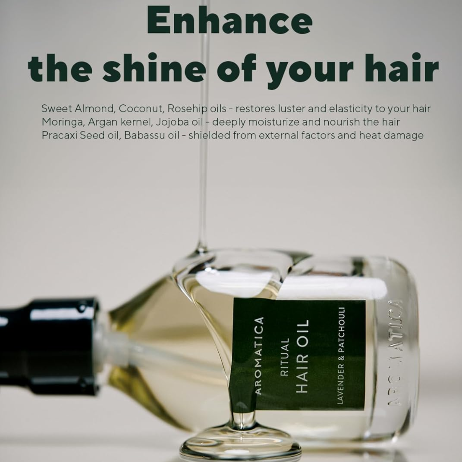 Aromatica Ritual Hair Oil bottle with text about hair care benefits on a light background