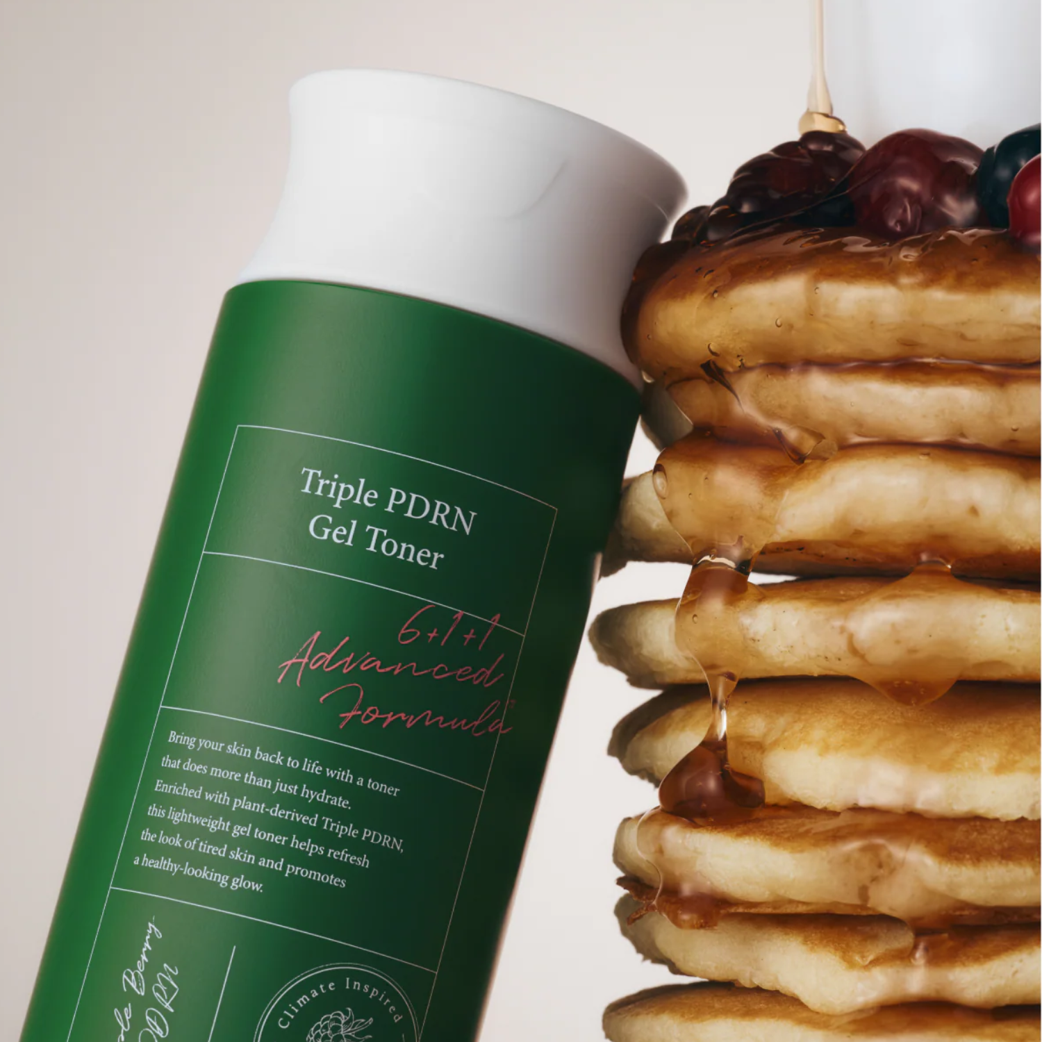 Green bottle of Triple PDRN Gel Toner next to a stack of pancakes with berries on a white background