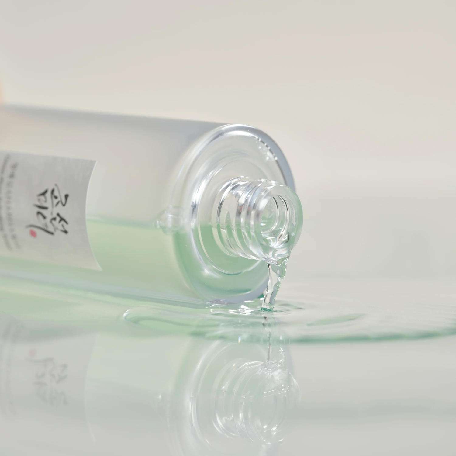 Close-up of a bottle with a clear liquid on a light gray background