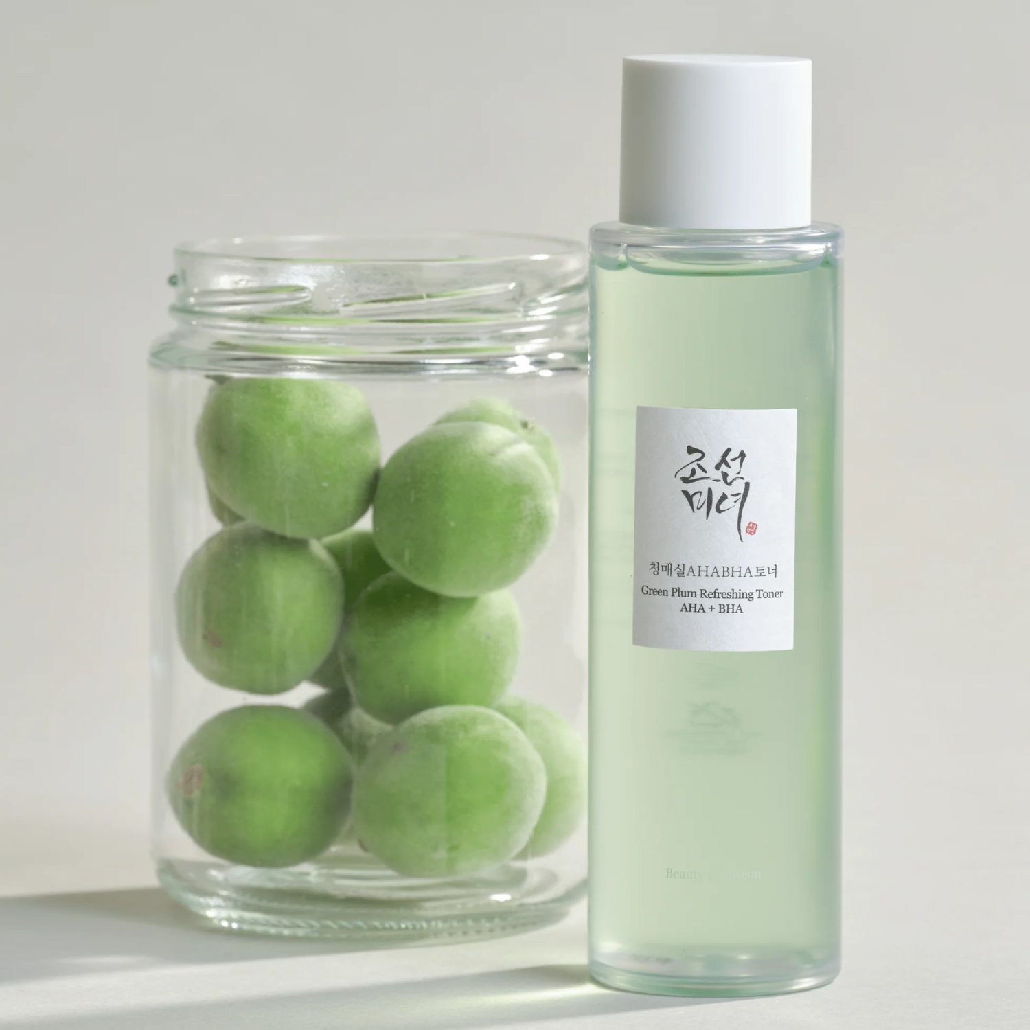 Skincare product with green marbles in a jar on a light background