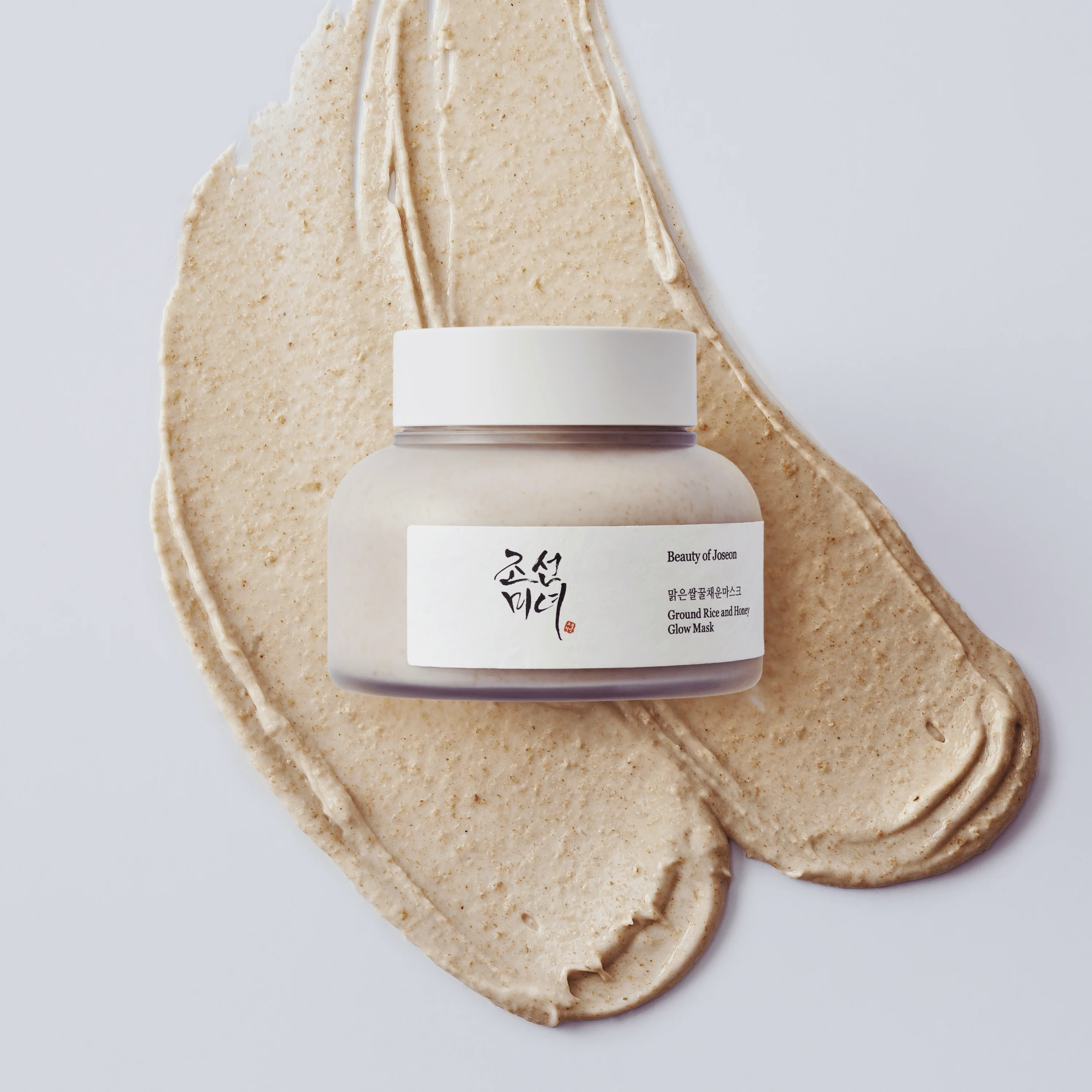 Jar of cream with a visible brand label on a light gray background