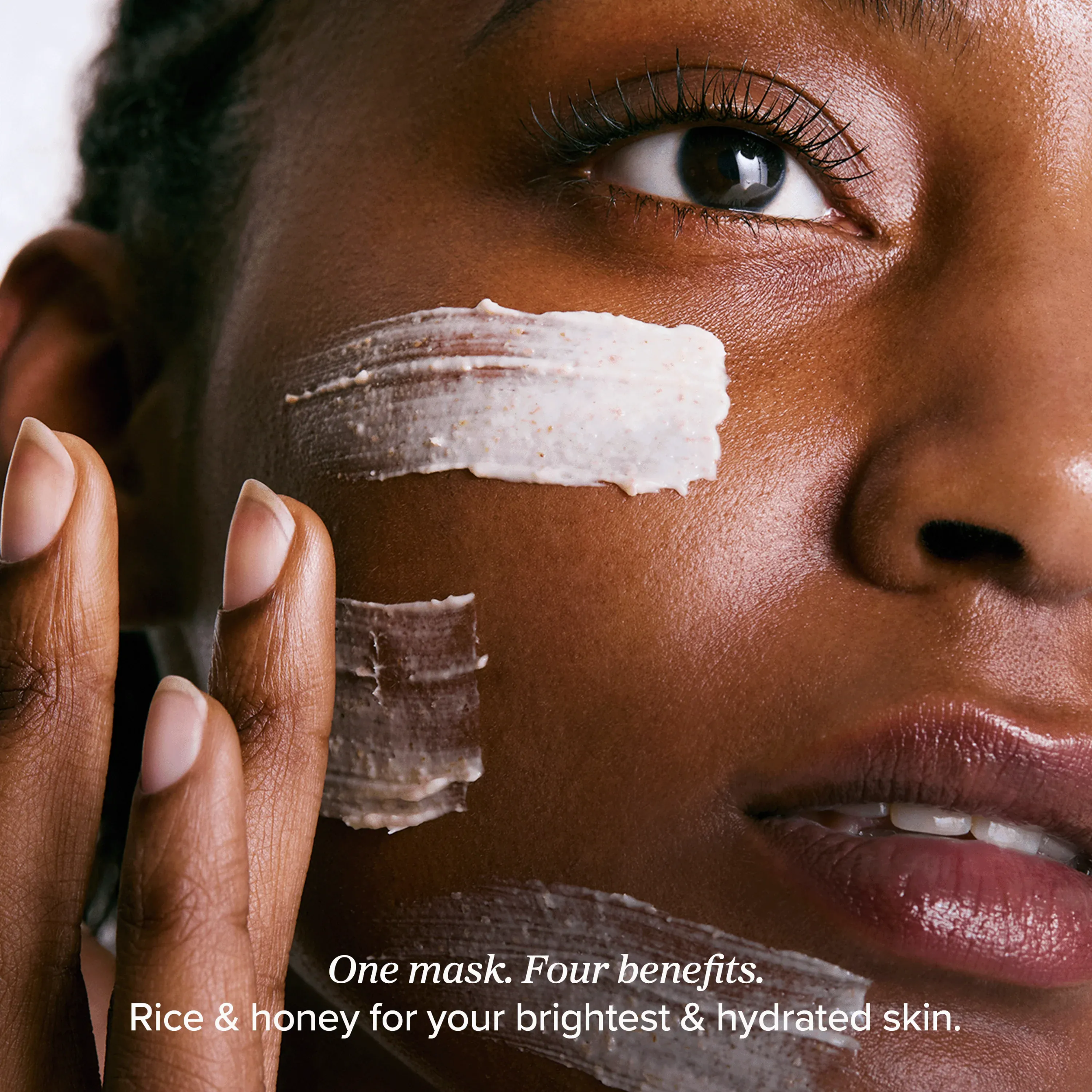 Close-up of a woman's face with a skincare product applied, promoting rice and honey benefits.