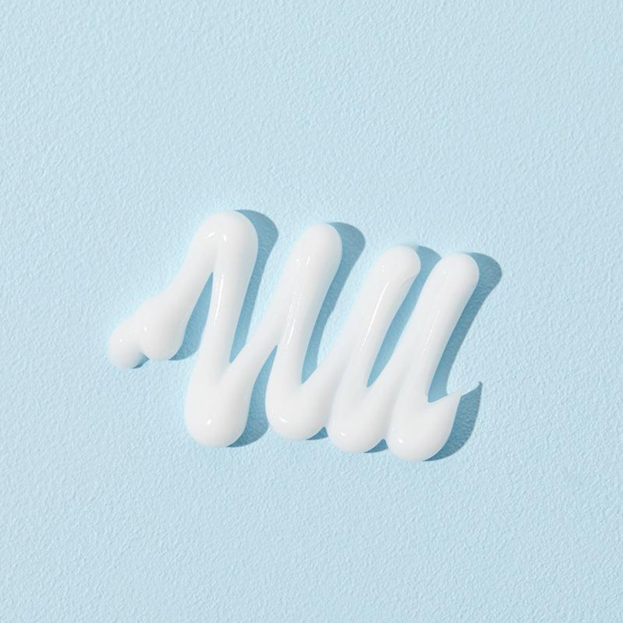 White cream swirl on a light blue background