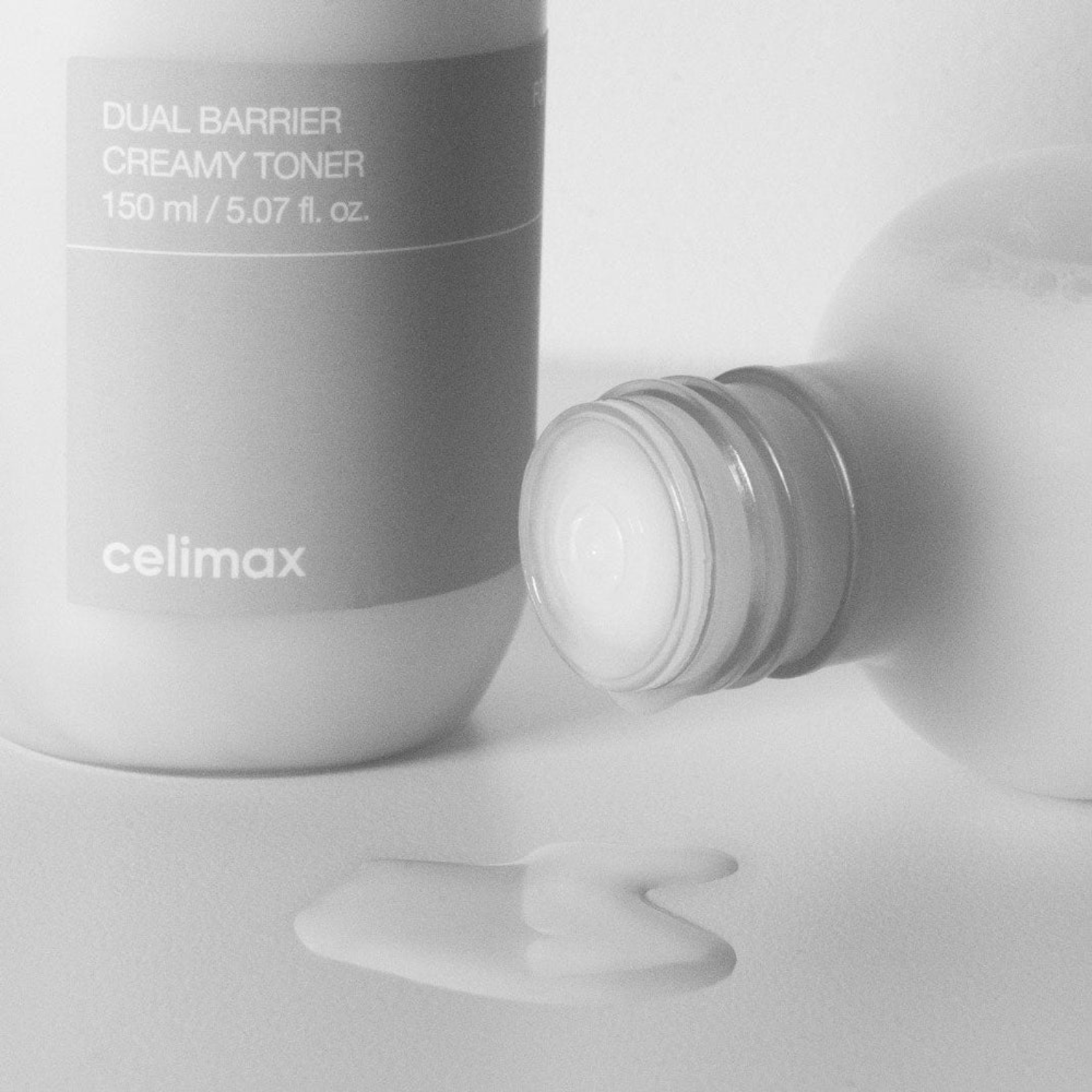 Celimax dual barrier creamy toner bottle with倒在白色的背景下