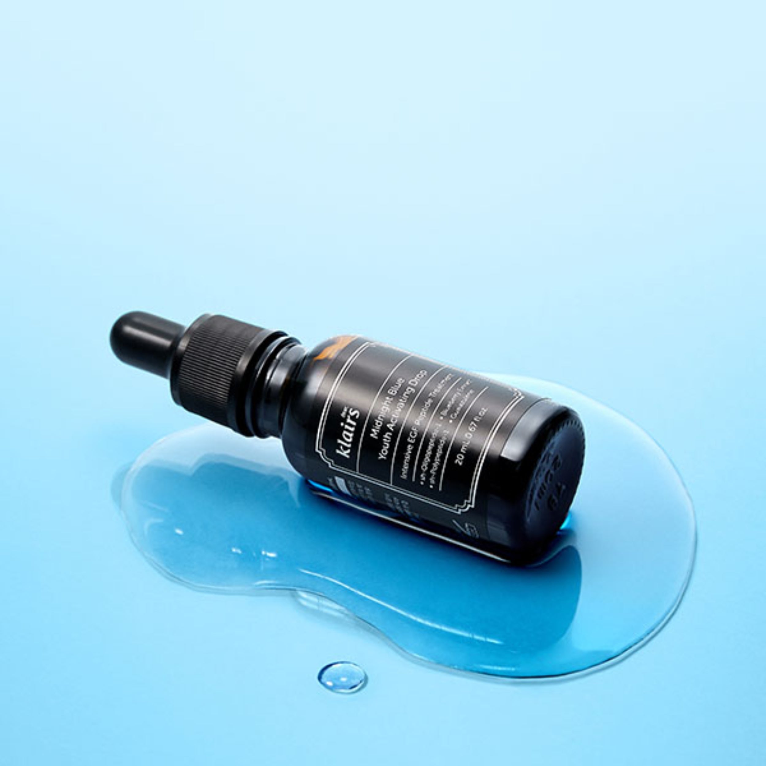 Black dropper bottle on a blue background