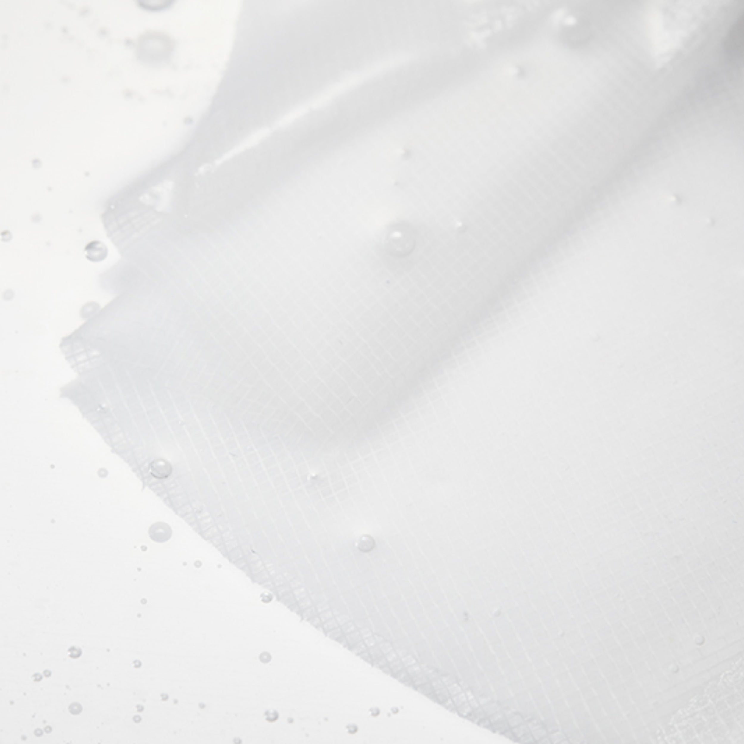 White fabric with water droplets on a white background
