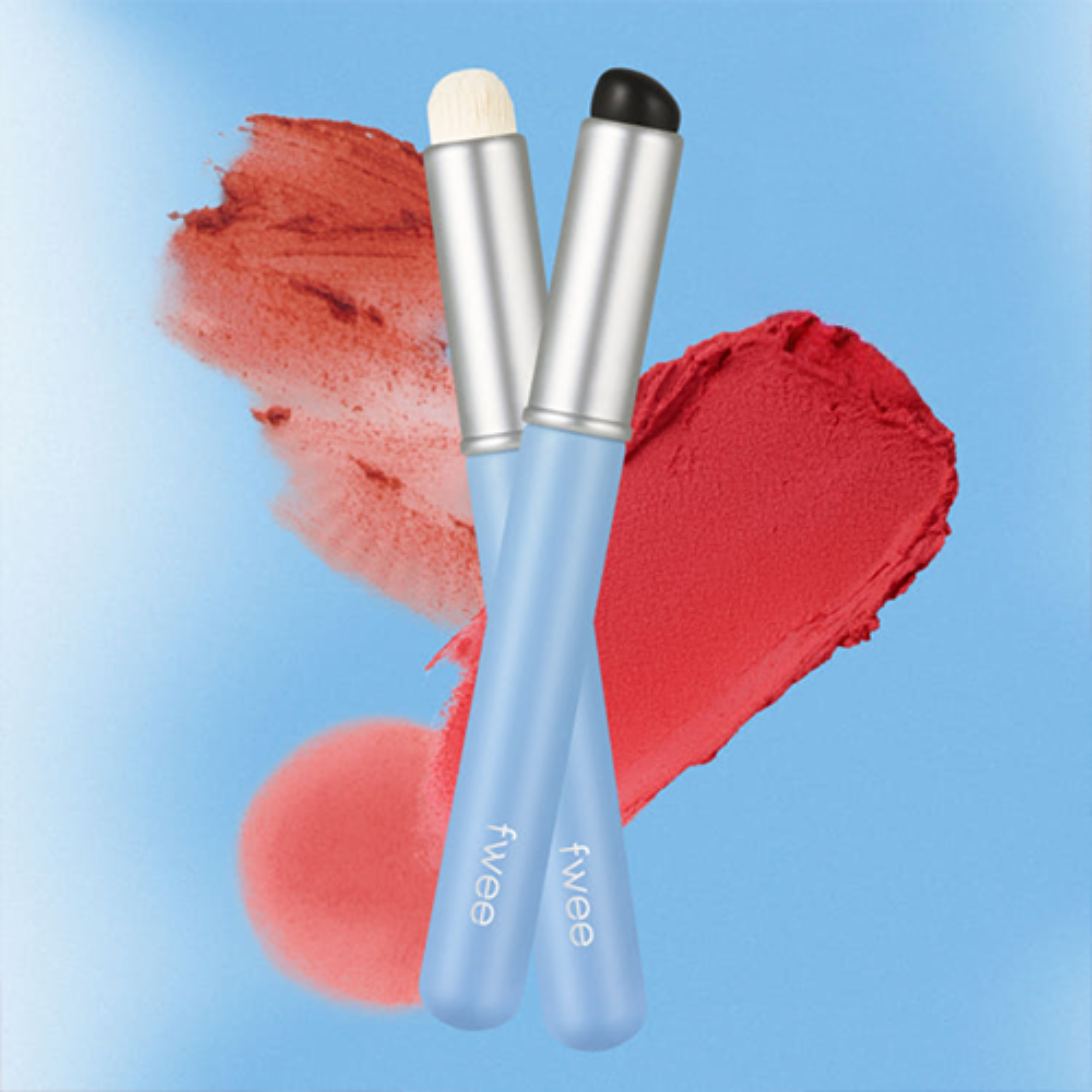 Two makeup brushes with red color swatches on a blue background, featuring the brand 'fwee'.