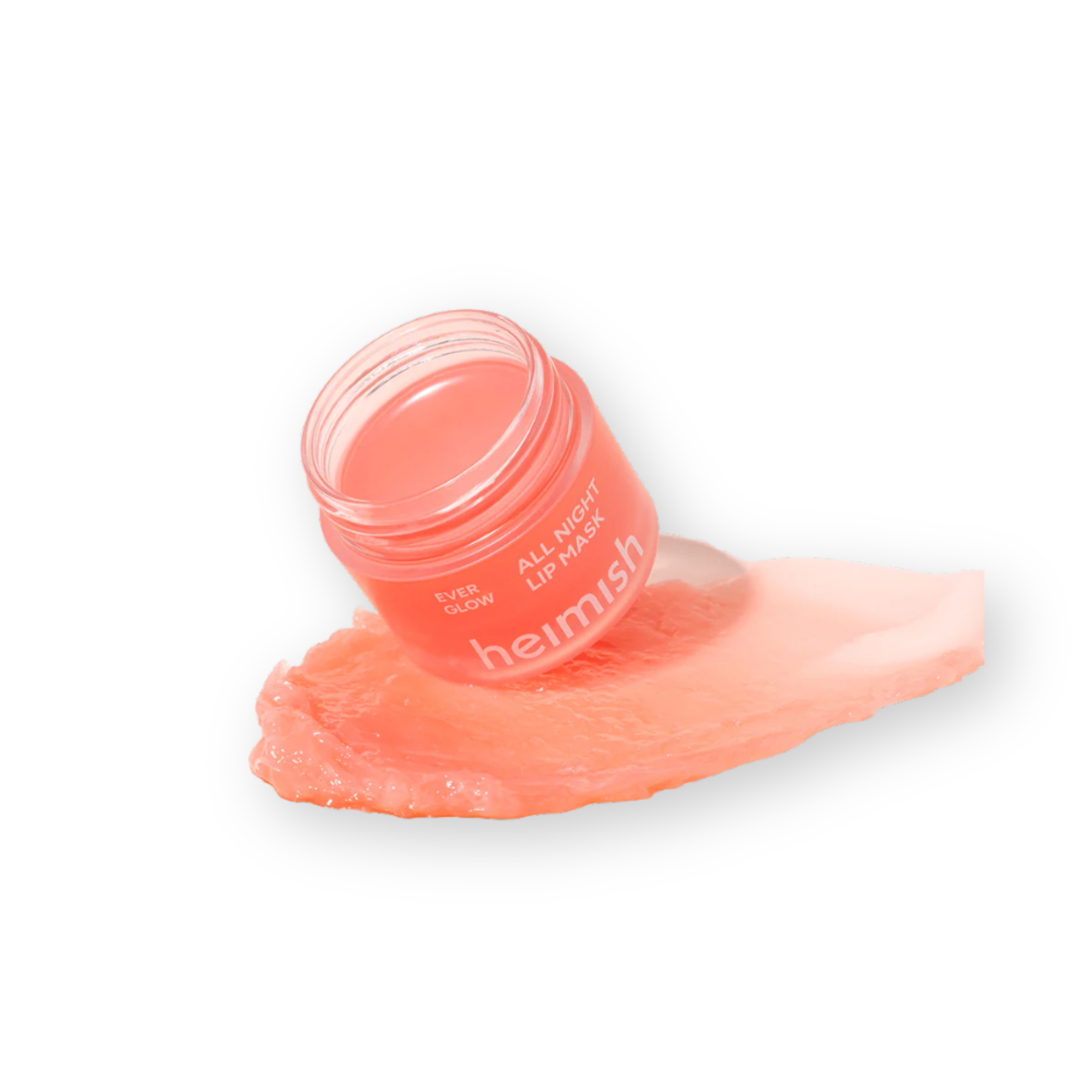 A small clear jar of Heimish All Night Lip Mask in a peachy pink shade, shown tipped on its side with some of the product smeared underneath on a white background.