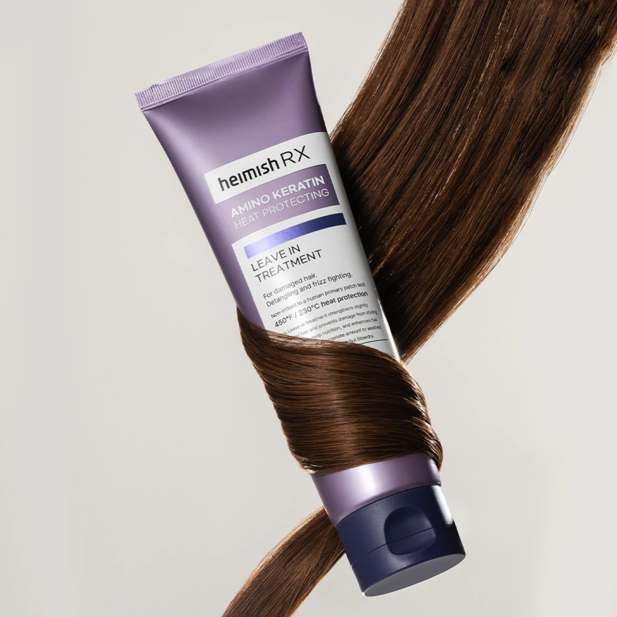 Hemish Rx Amino Keratin leave-in treatment tube with brown hair on a light gray background