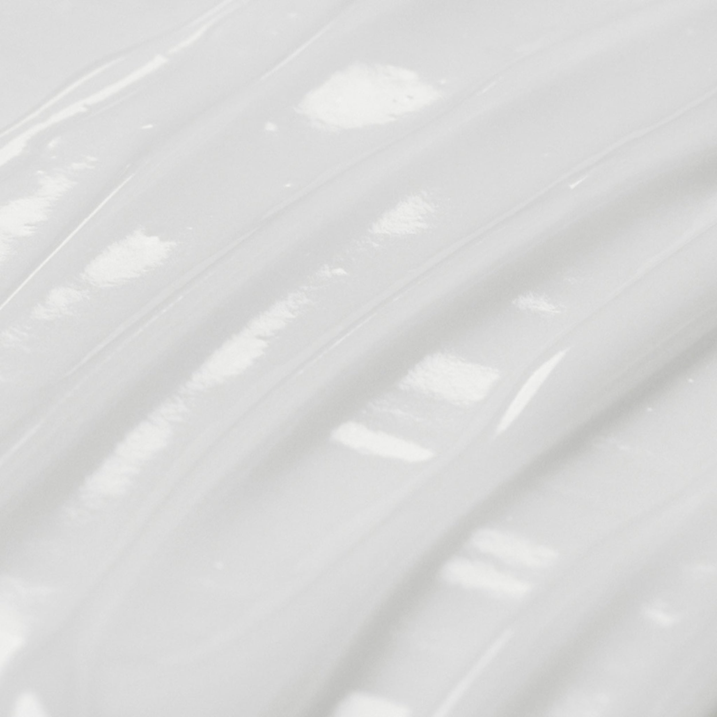 Close-up of a white, glossy surface with reflections