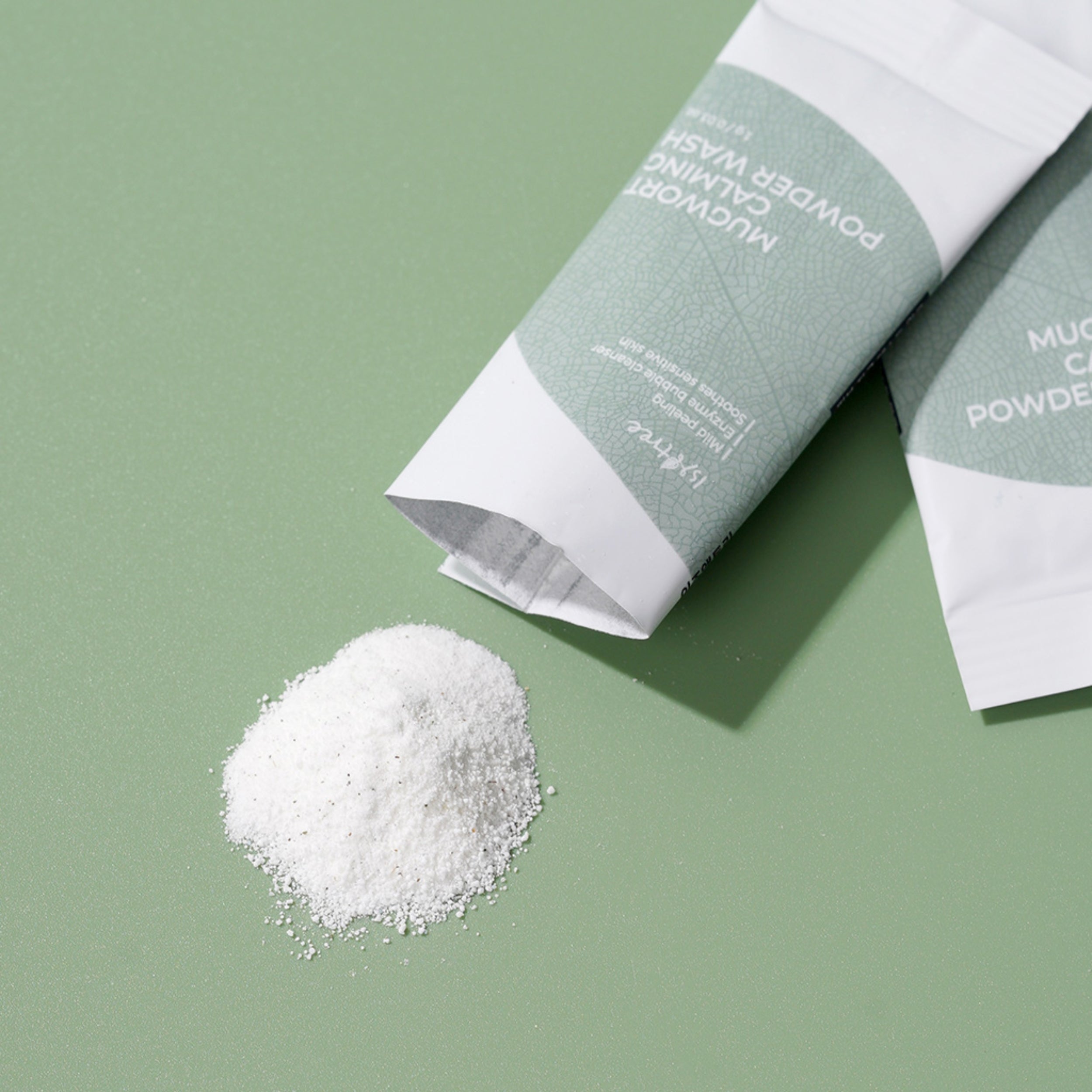 Mucinex Powder on a green background