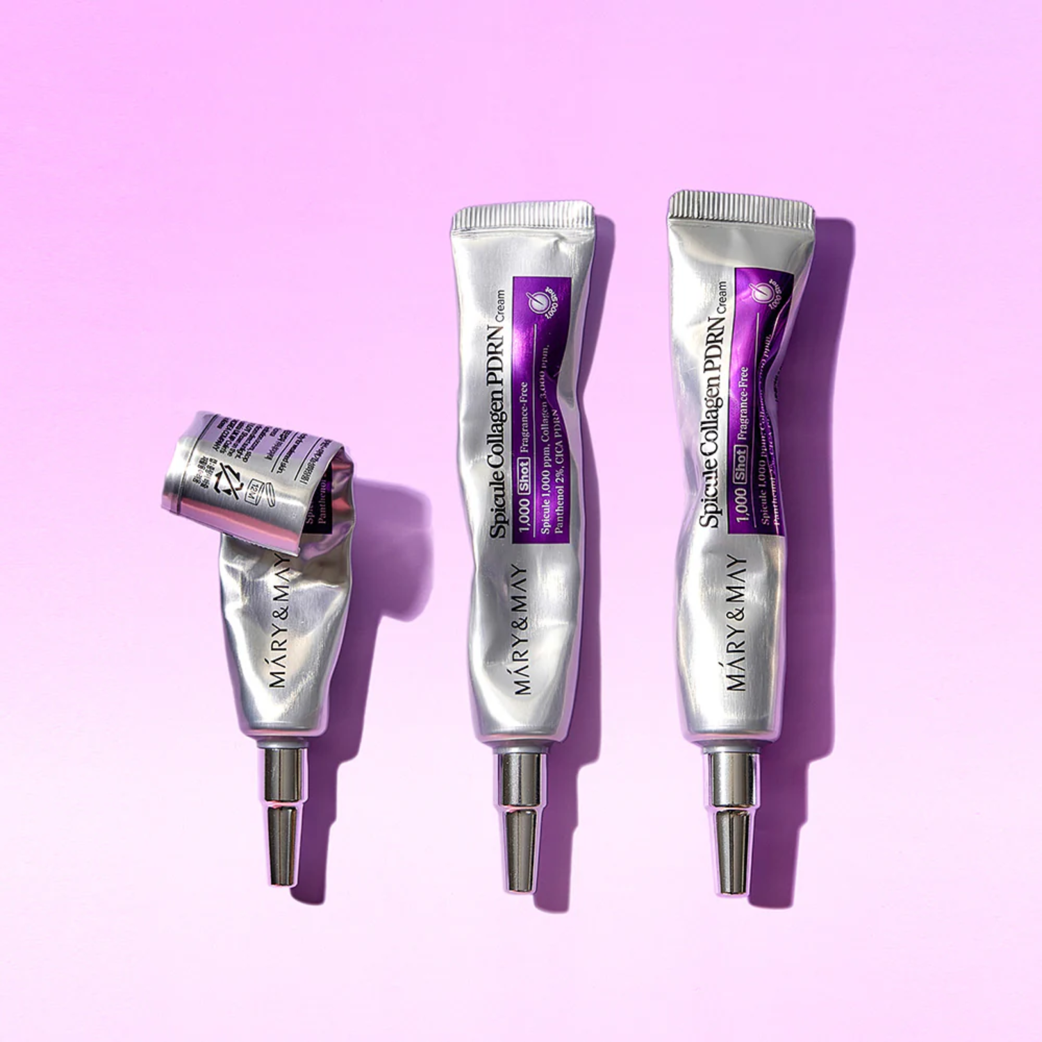 Three skincare product tubes with a purple background