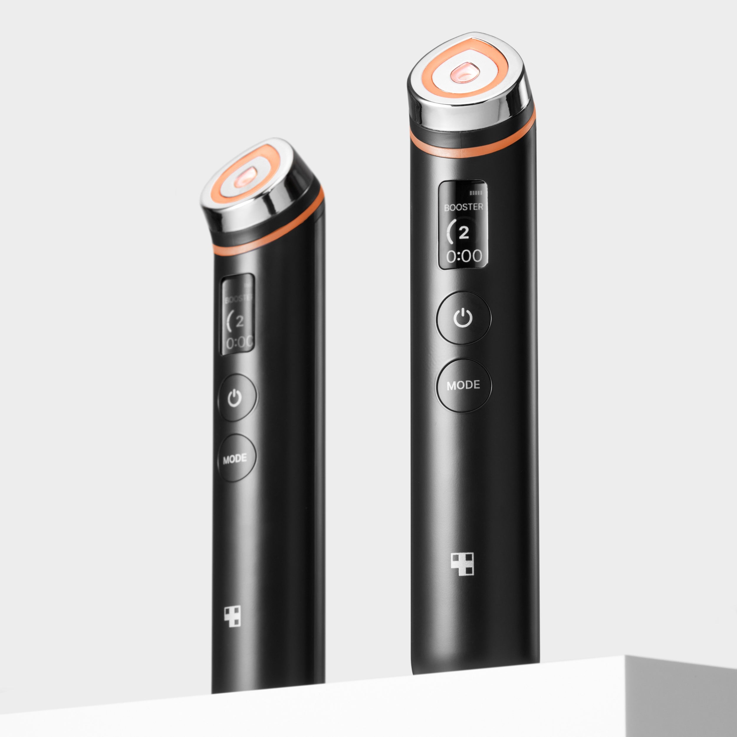 Two black electronic devices with orange accents on a white background