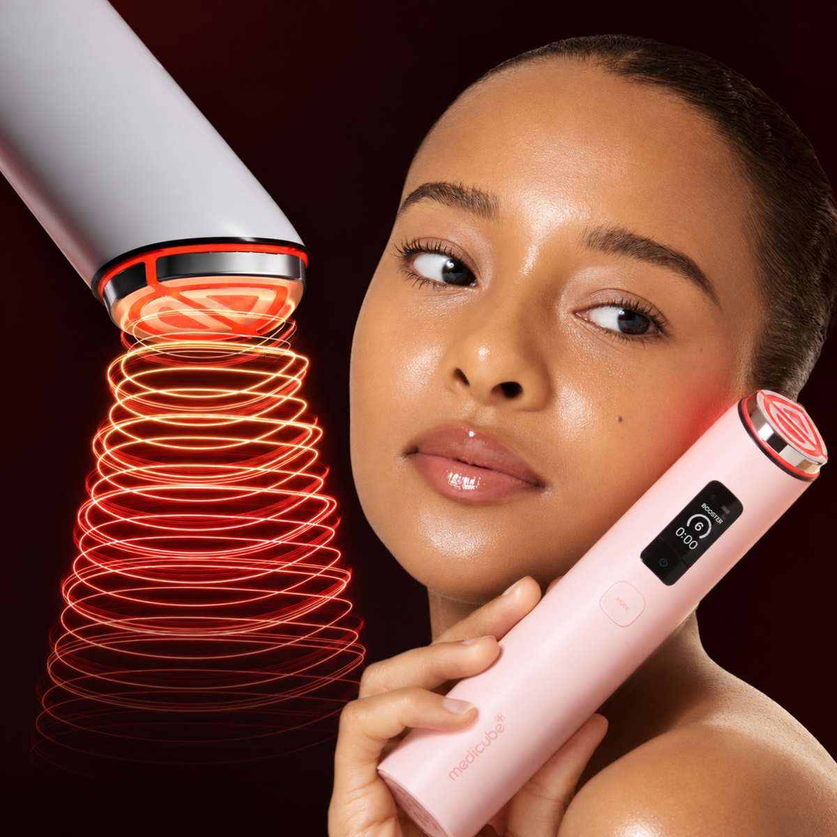 A woman holds a pink red-light therapy device against her face while another device projects a red light cone onto her skin, set against a dark red background.
