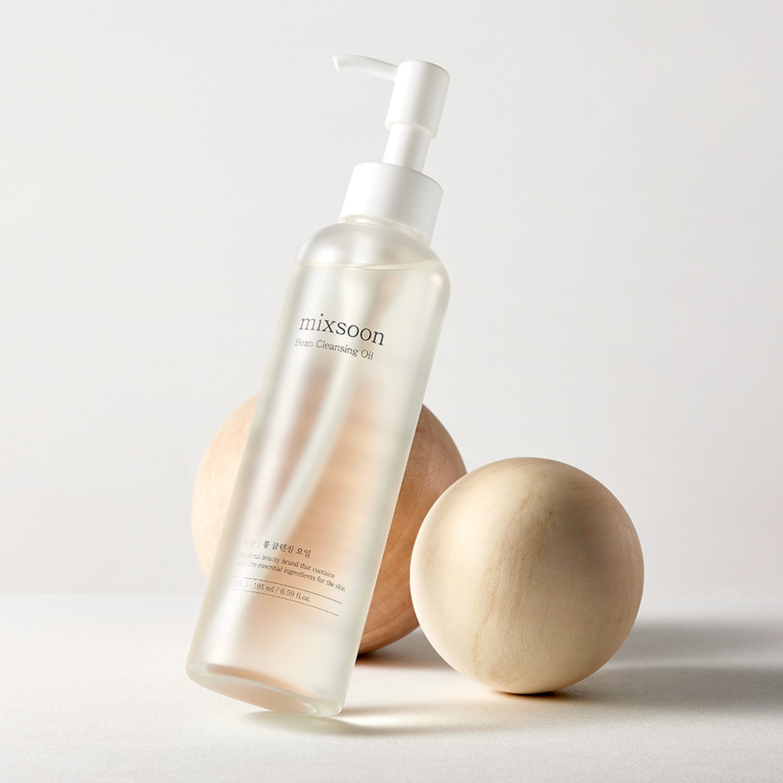 Skincare bottle with wooden applicators on a light background