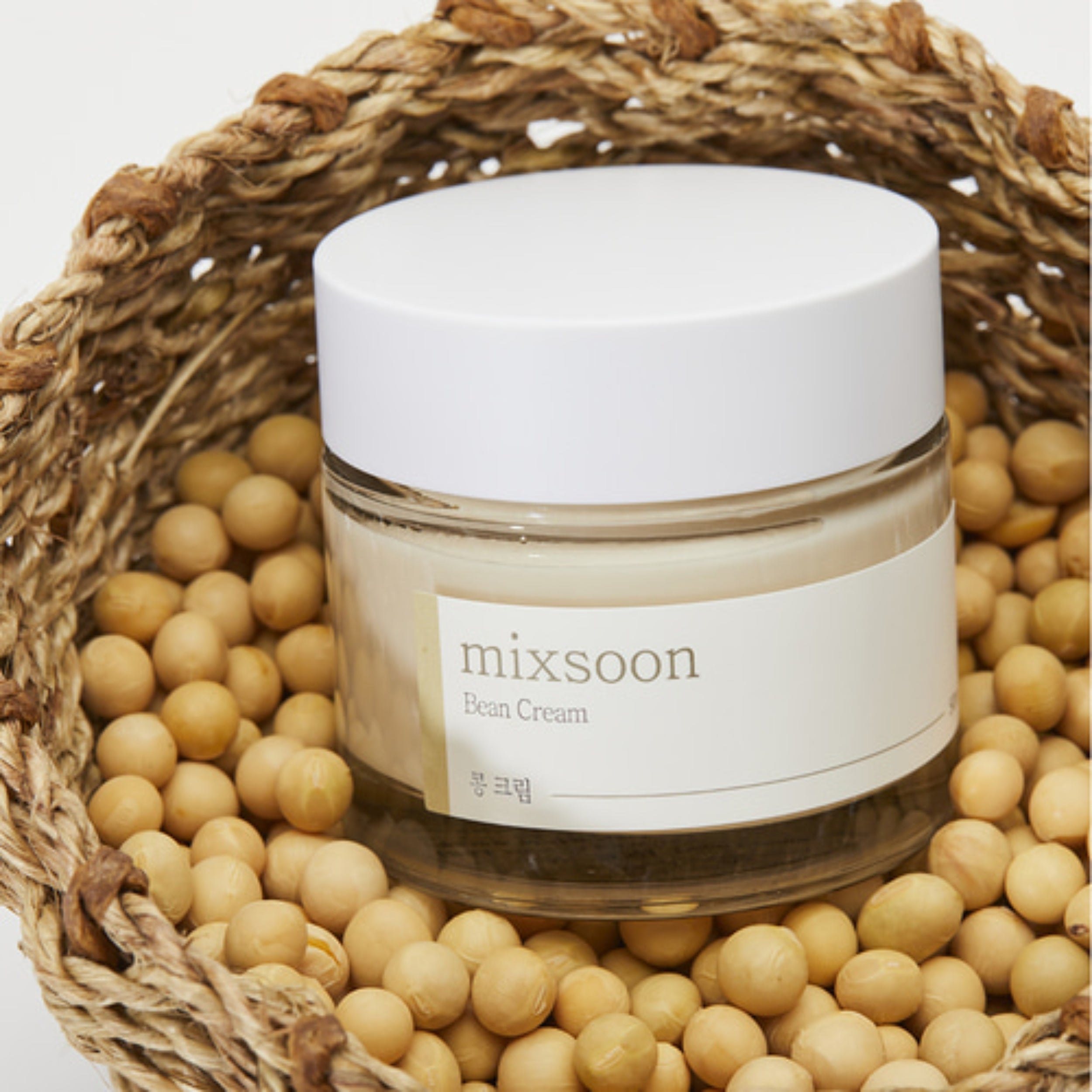 Jar of 'mixsoon' bean cream surrounded by soybeans in a woven basket