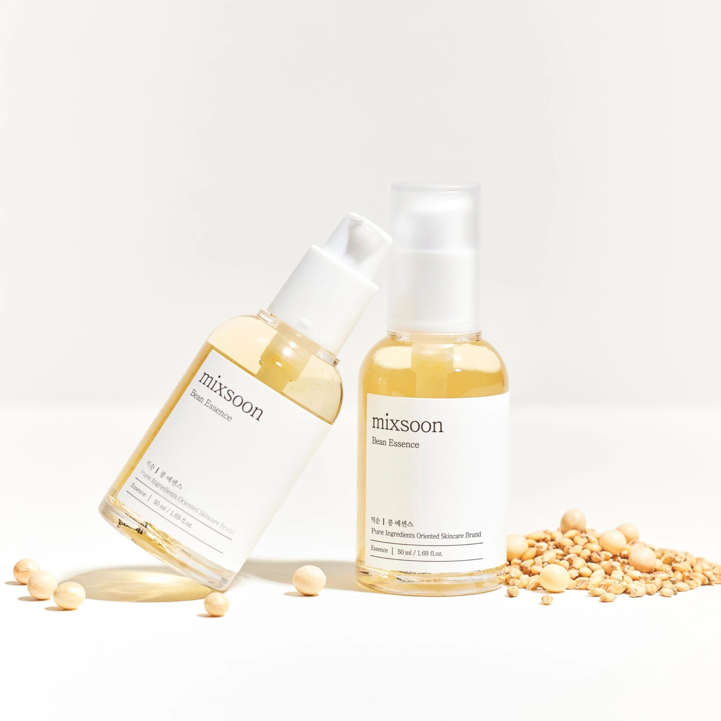 Two bottles of mixsoon face essence with seeds on a light background