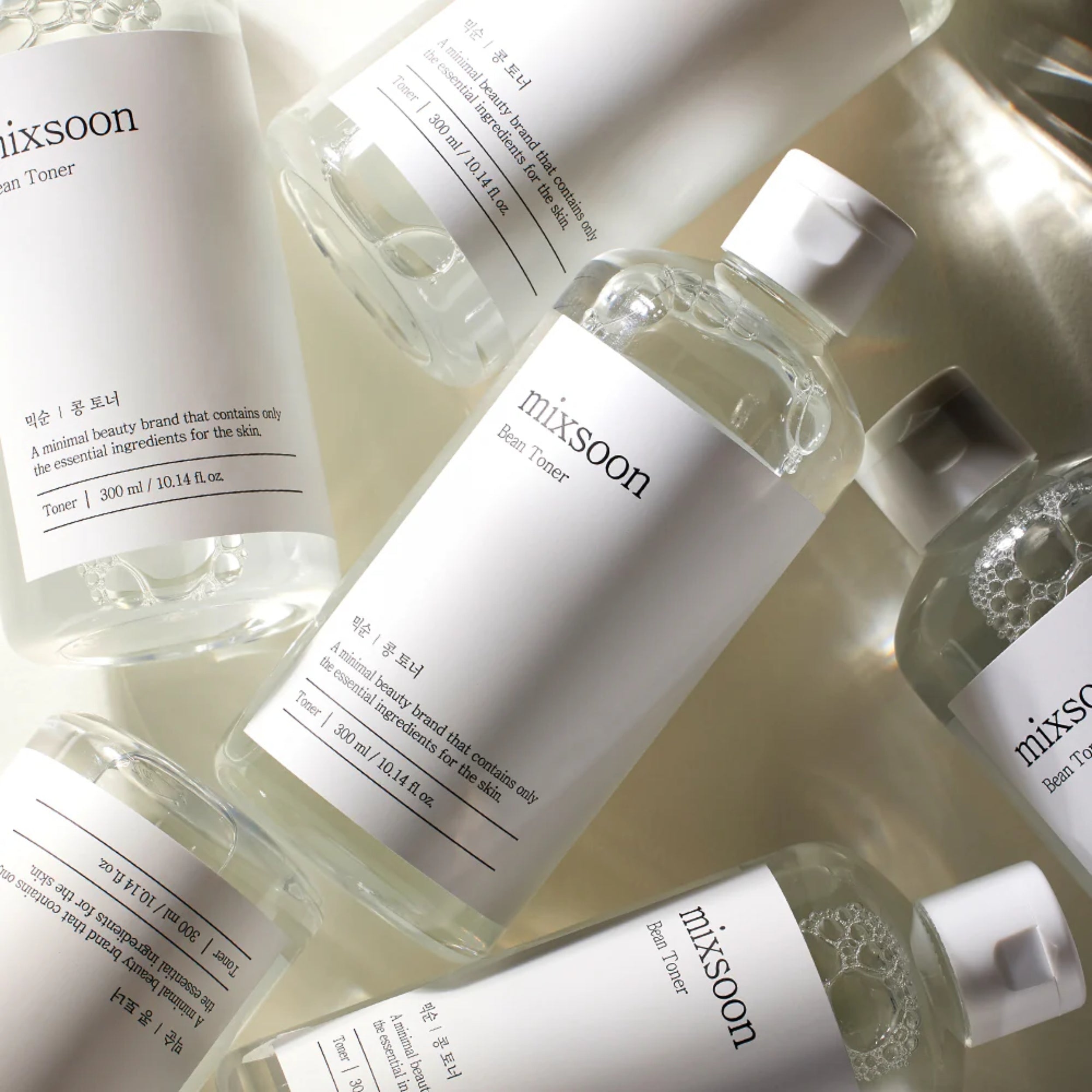 Multiple bottles of mixsoon toner on a light background