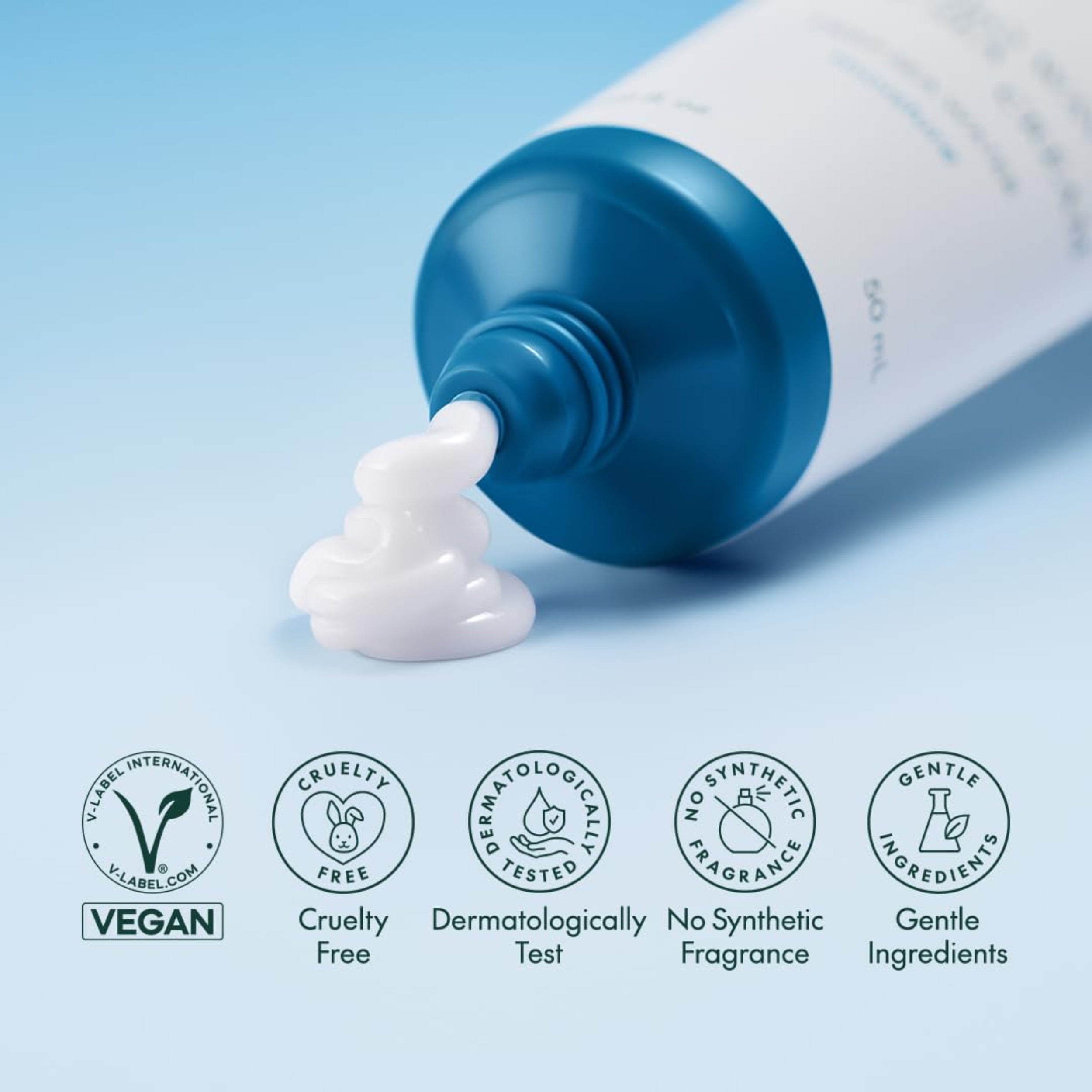 Tube of cream with a blue cap on a light blue background, featuring ethical and safety certification logos.