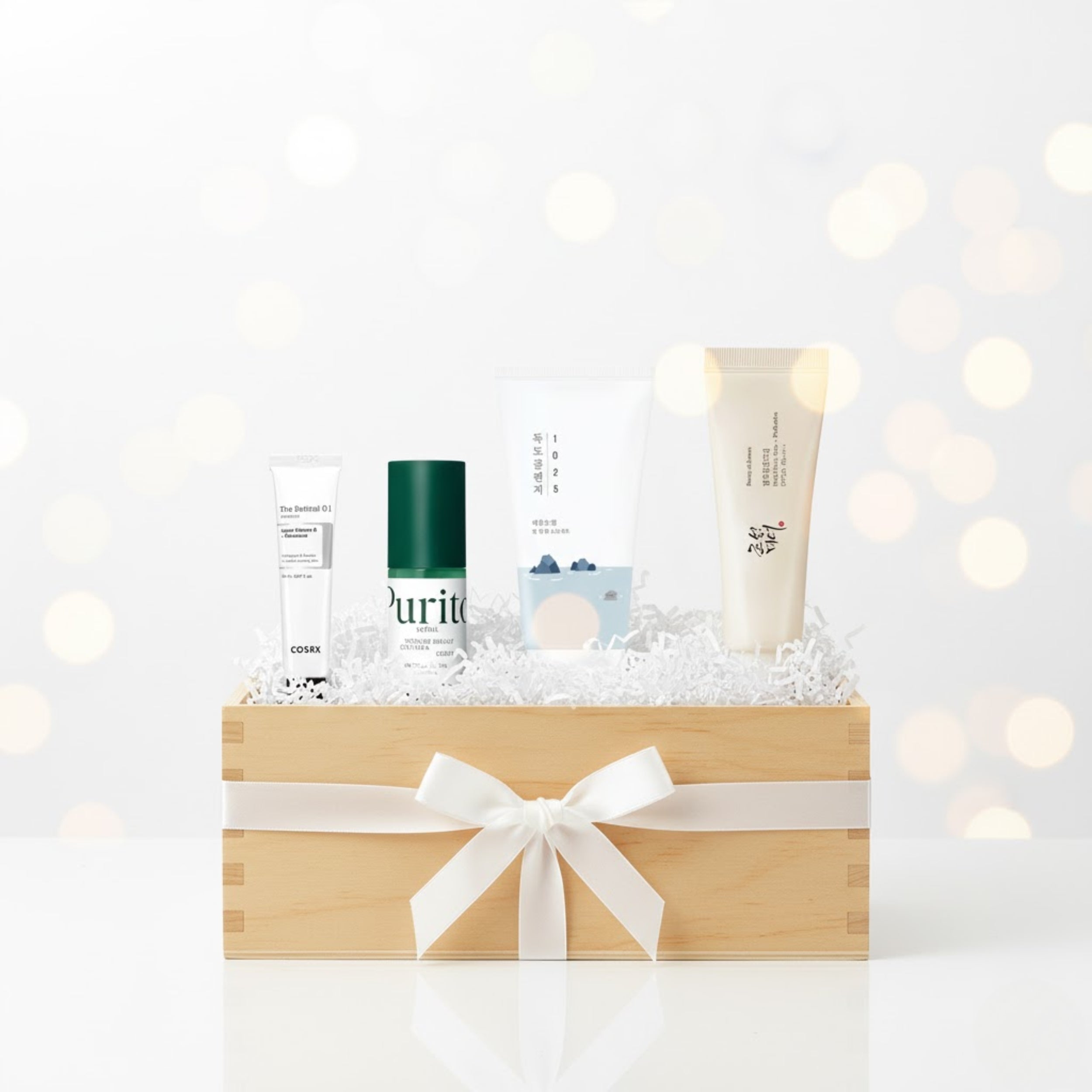 Cosmetic set with bottles and a tube in a wooden box on a white background