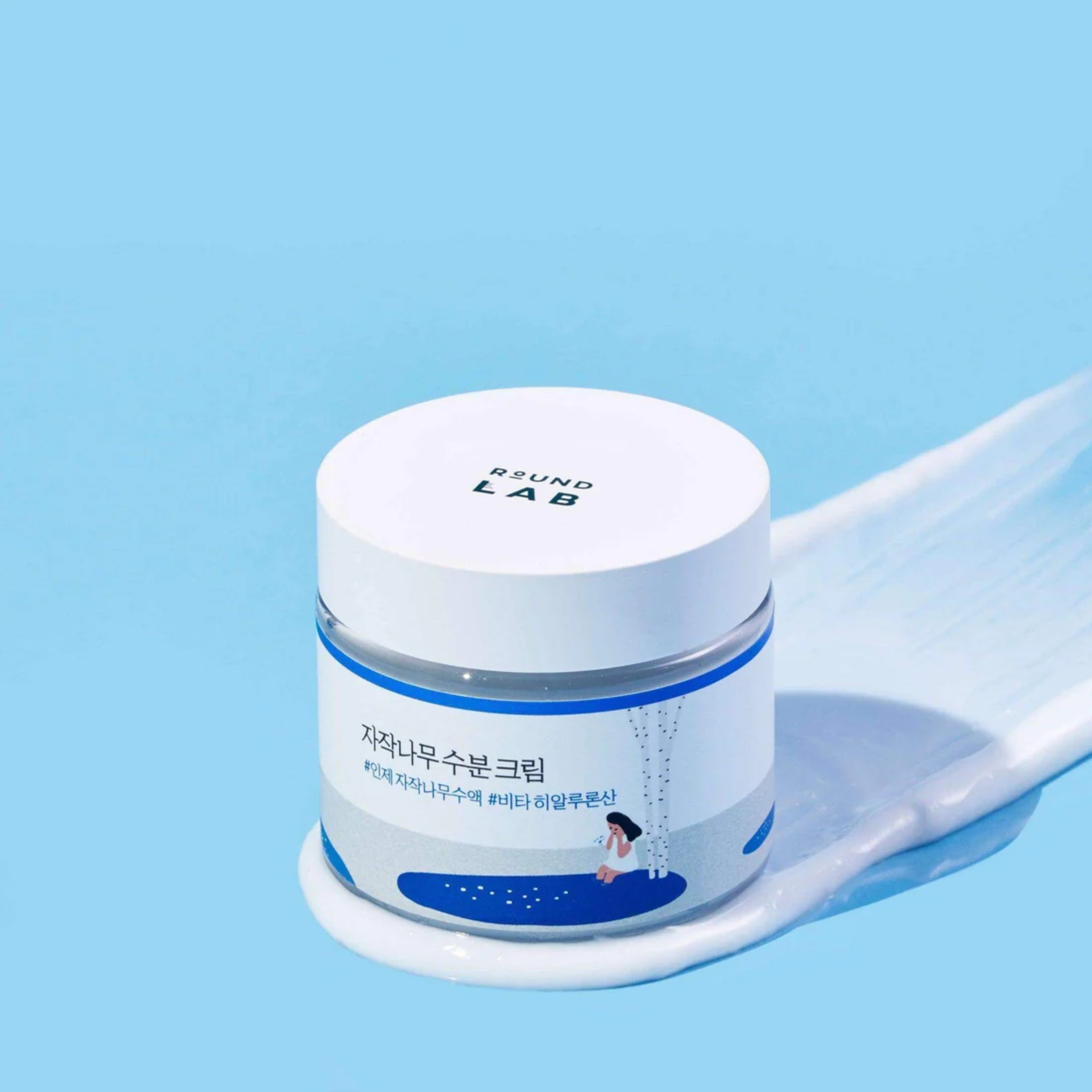 Skincare birch juice moisturizing cream 
jar with a white lid on a blue background