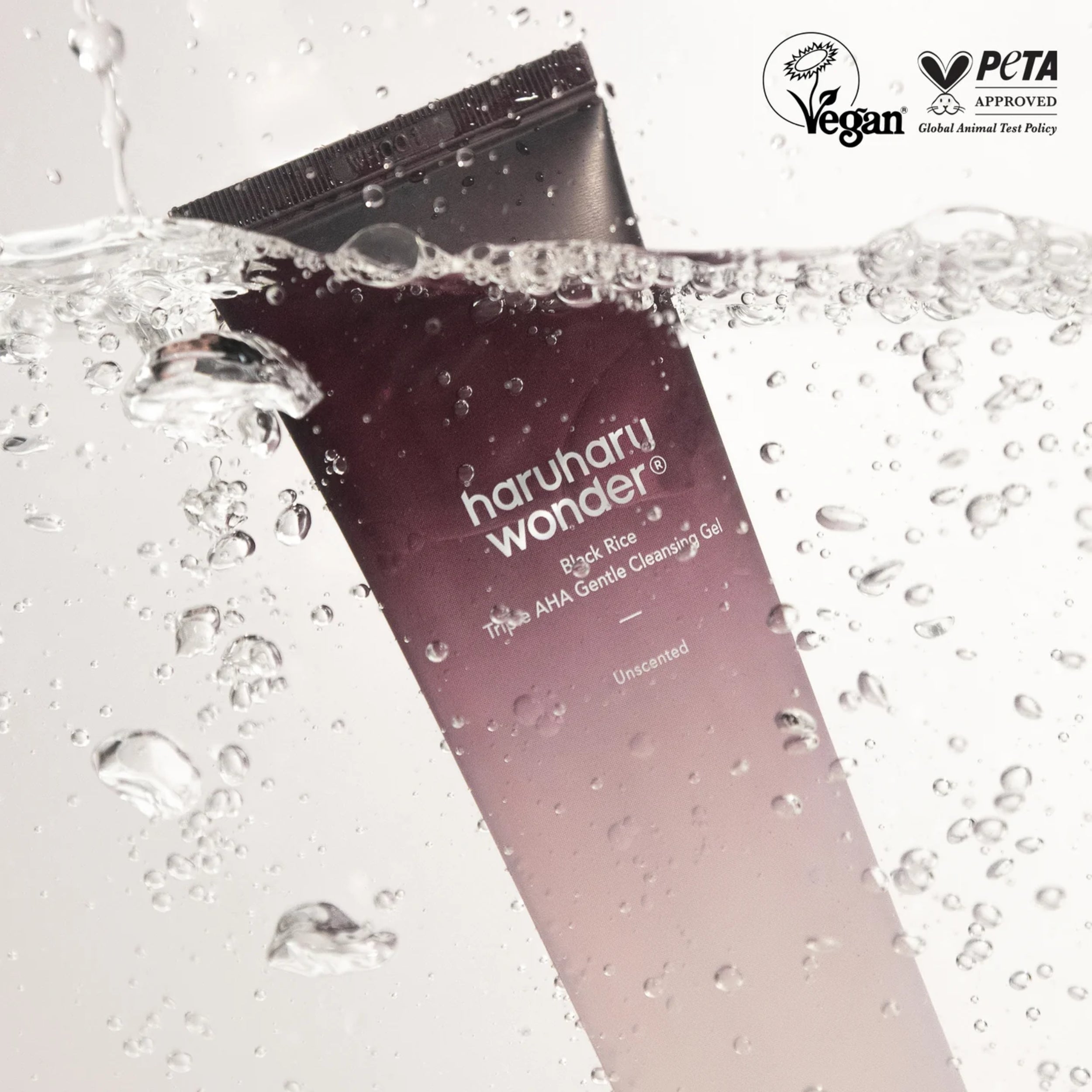 Haruharu Wonder cleansing gel bottle with water droplets on a light gray background