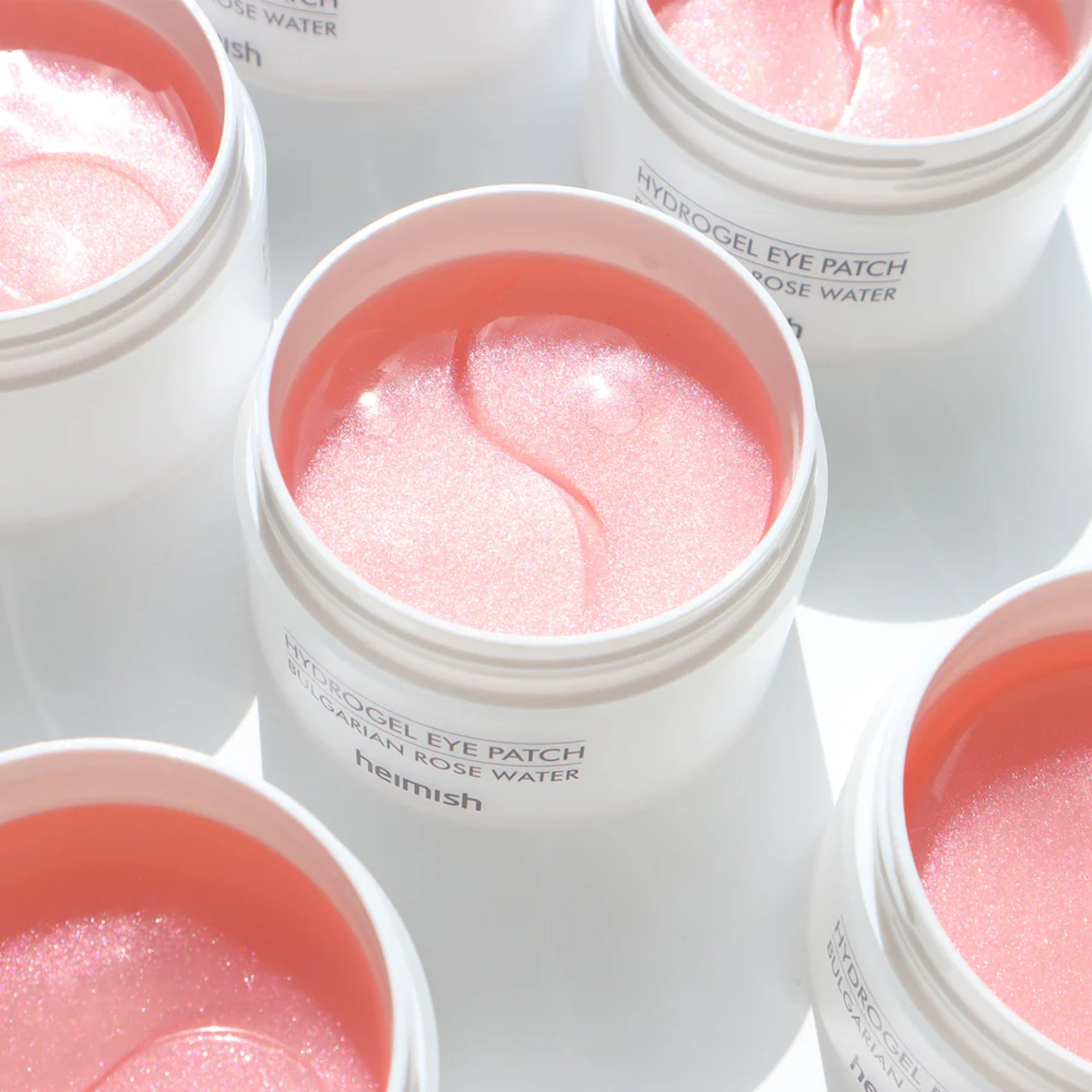 Heimish Hydrogel Eye Patch containers with pink eye patches inside on a white background