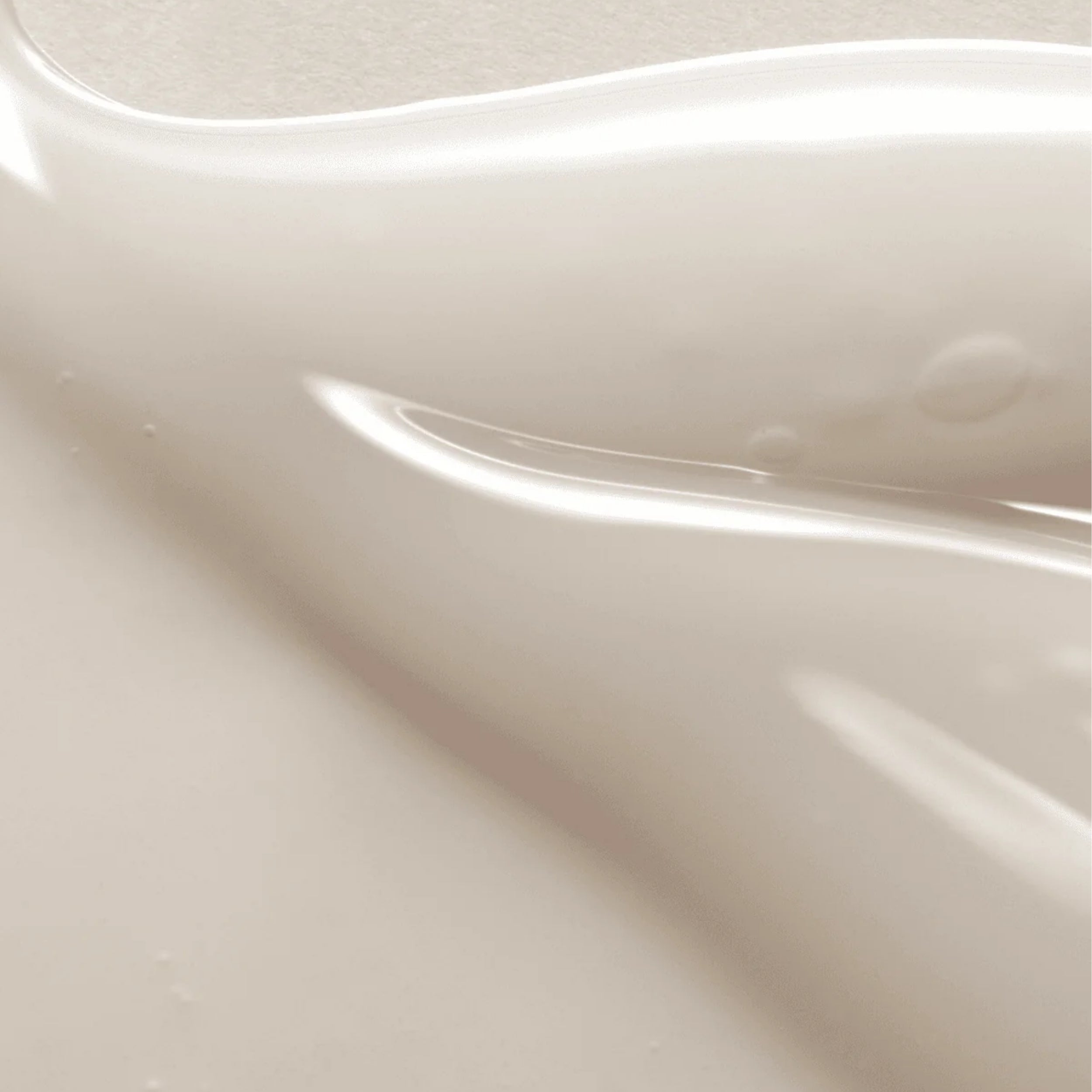 Close-up of a white Axis-Y Dark spot correcting glow serum with a glossy finish.