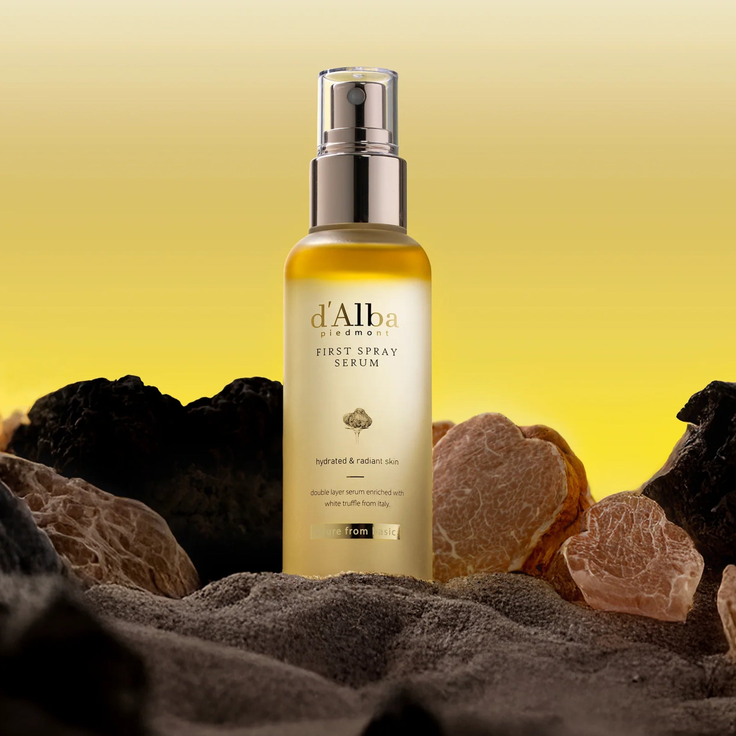 d'Alba first spray serum bottle with natural elements on a yellow background