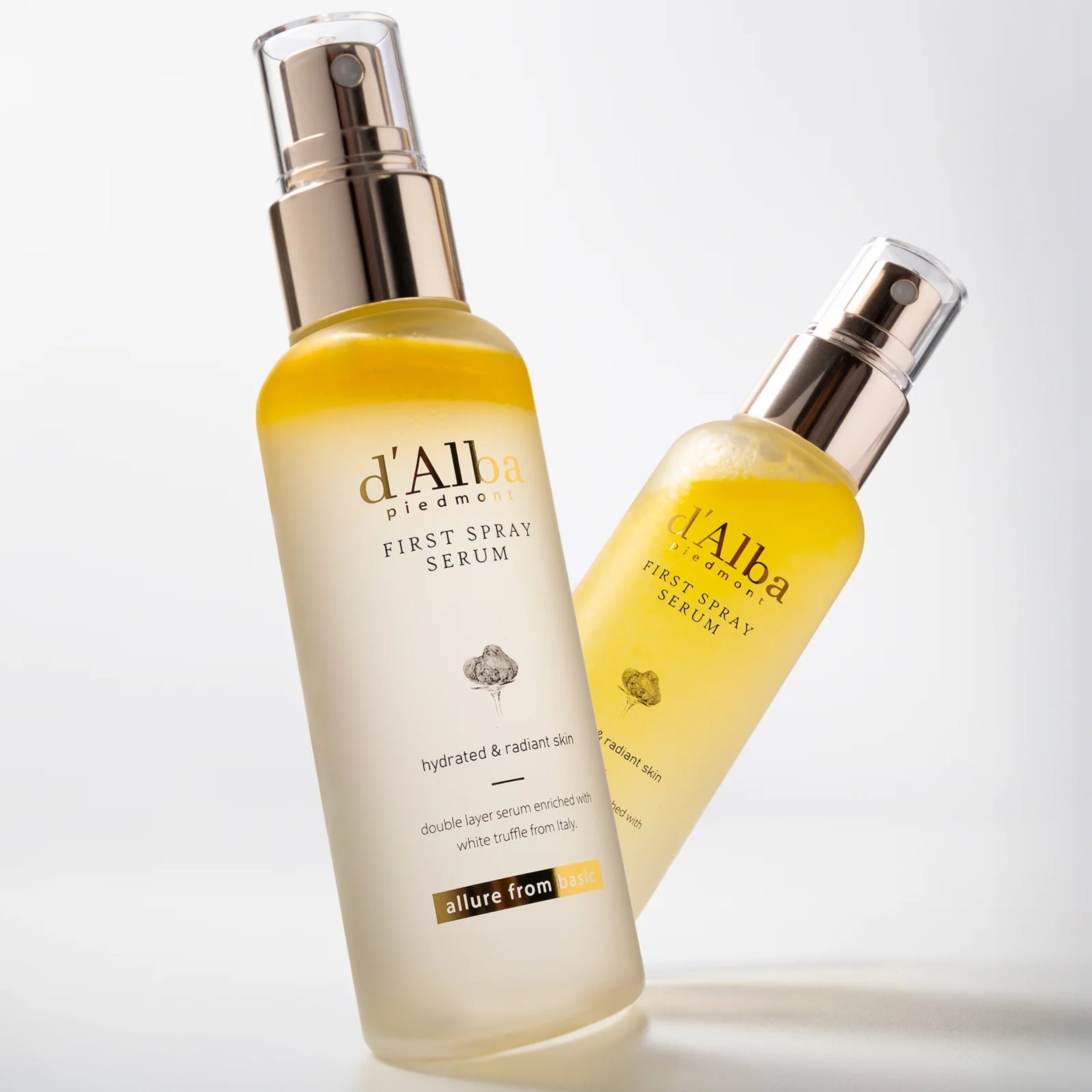Two bottles of d'Alba First Spray Serum on a light background