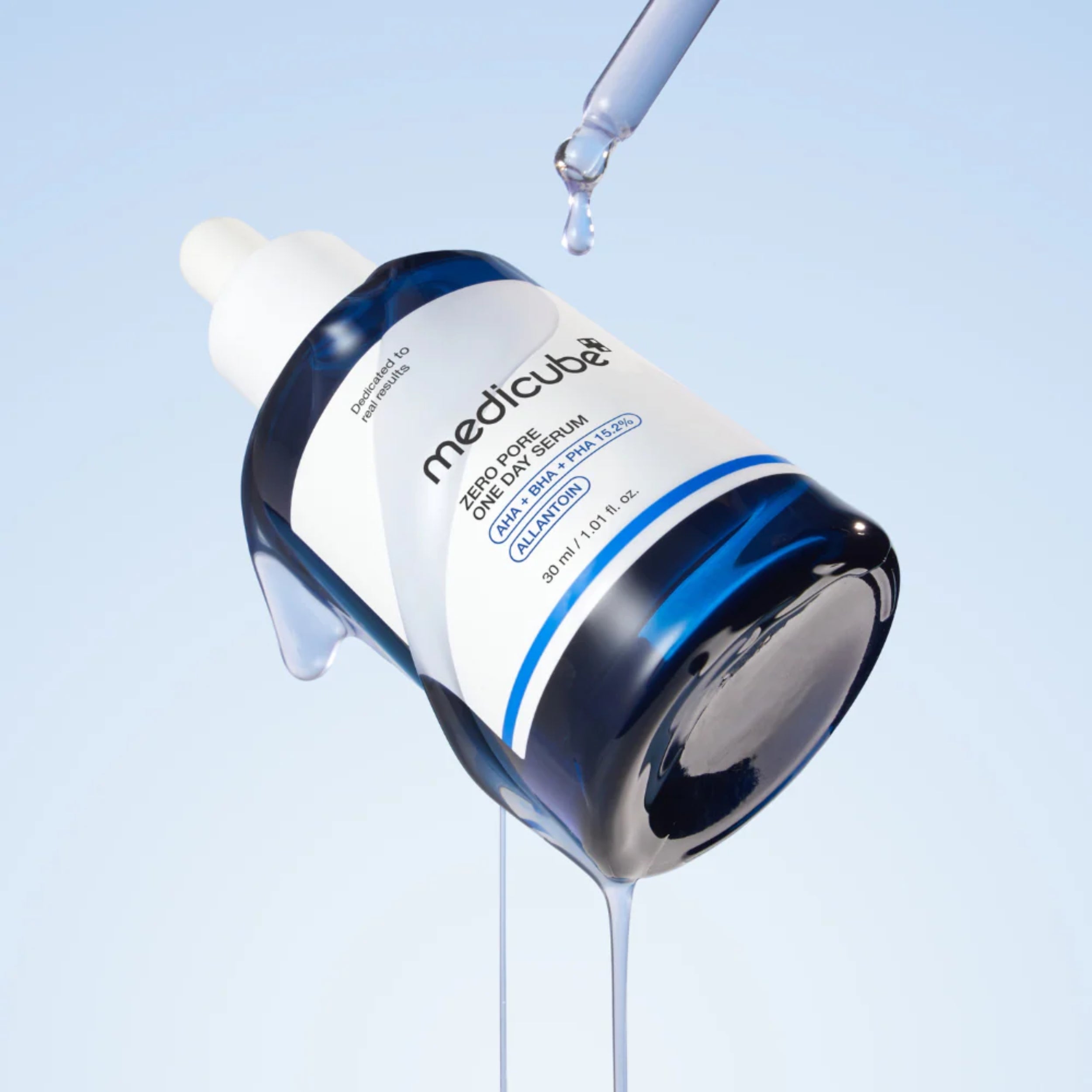 Medicube serum bottle with dropper on a light blue background