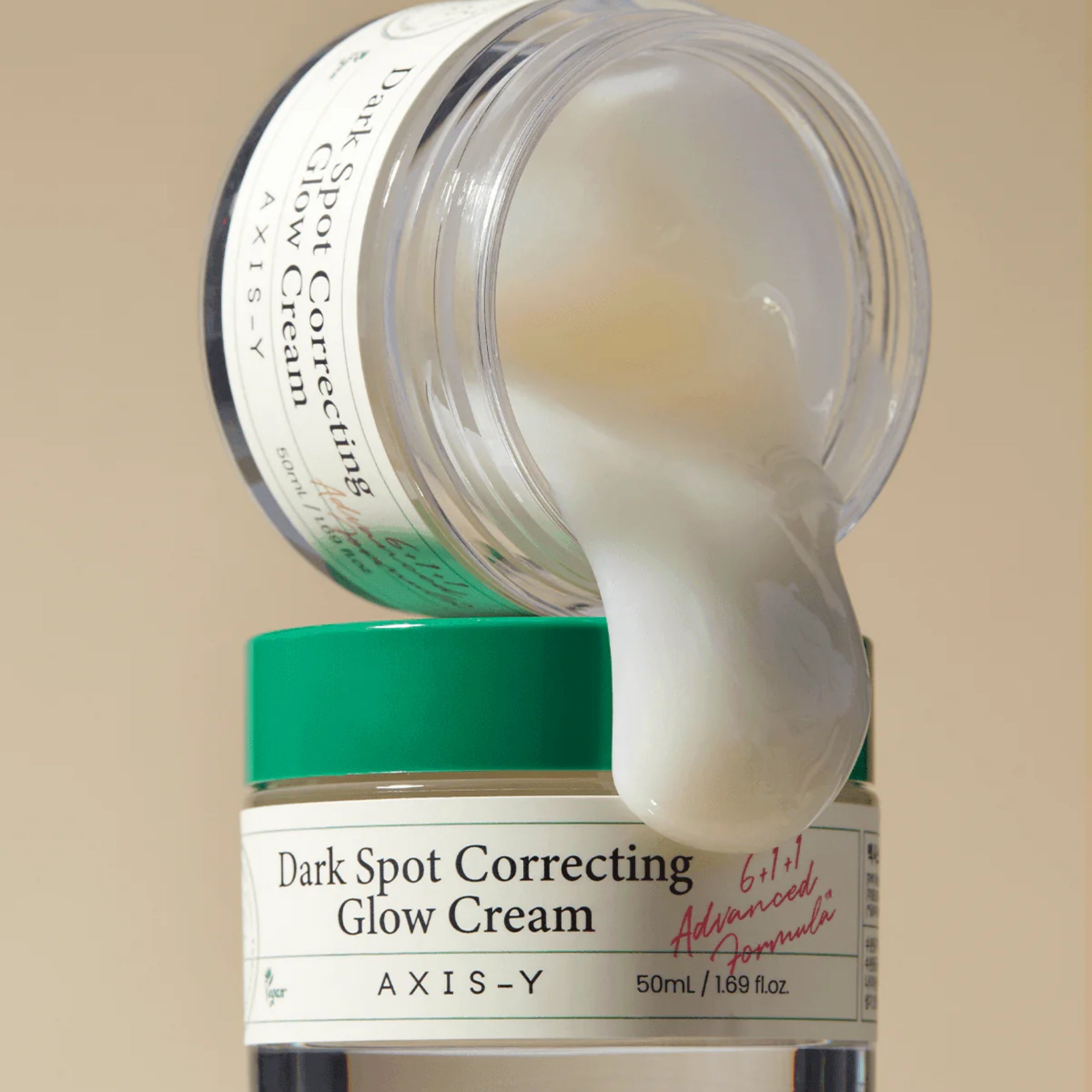  AXIS-Y Dark Spot Correcting Glow Cream jar with cream oozing out on a beige background