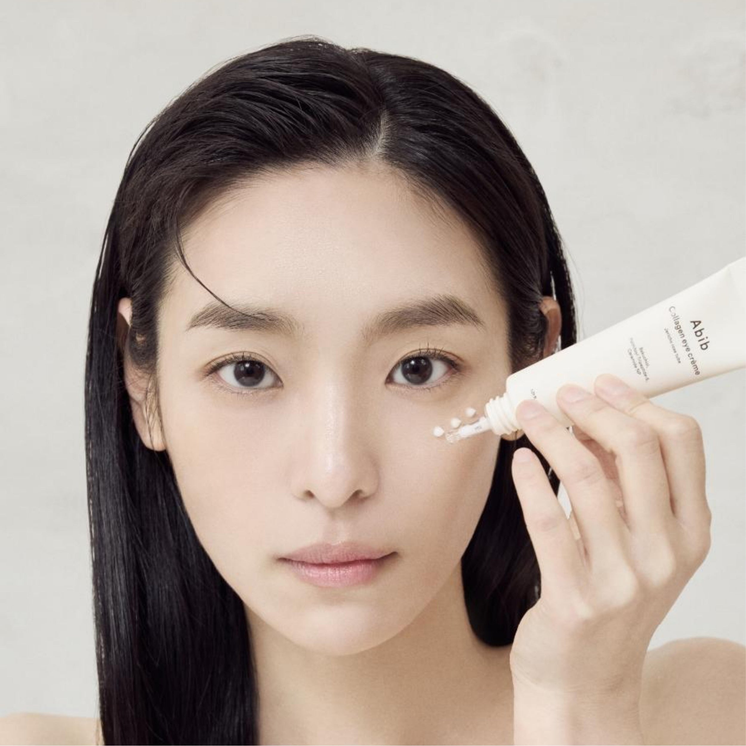 Woman applying Abib Collagen Eye Cream under eyes for hydration