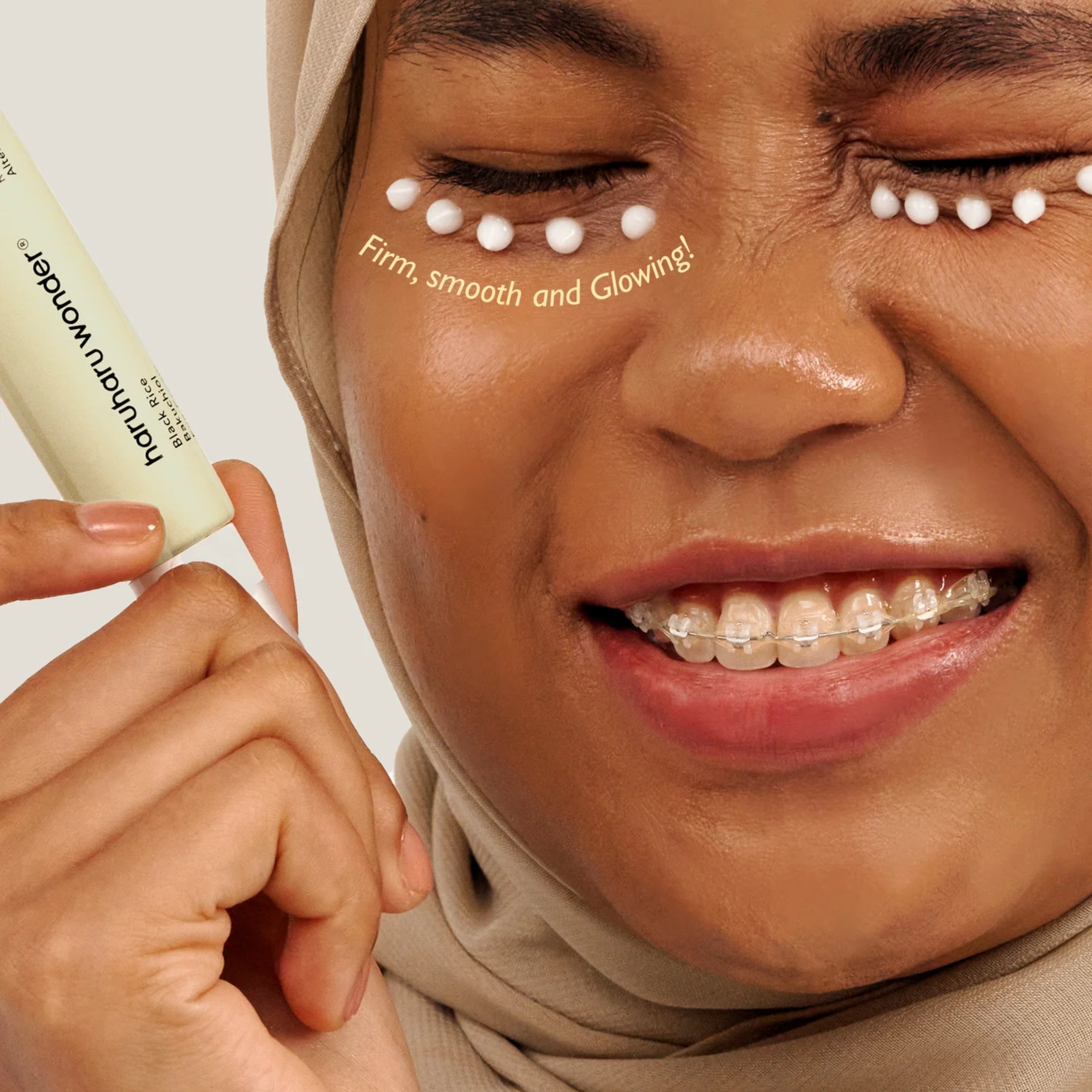 Woman applying skincare product with text 'Firm, smooth and glowing!' on her face.