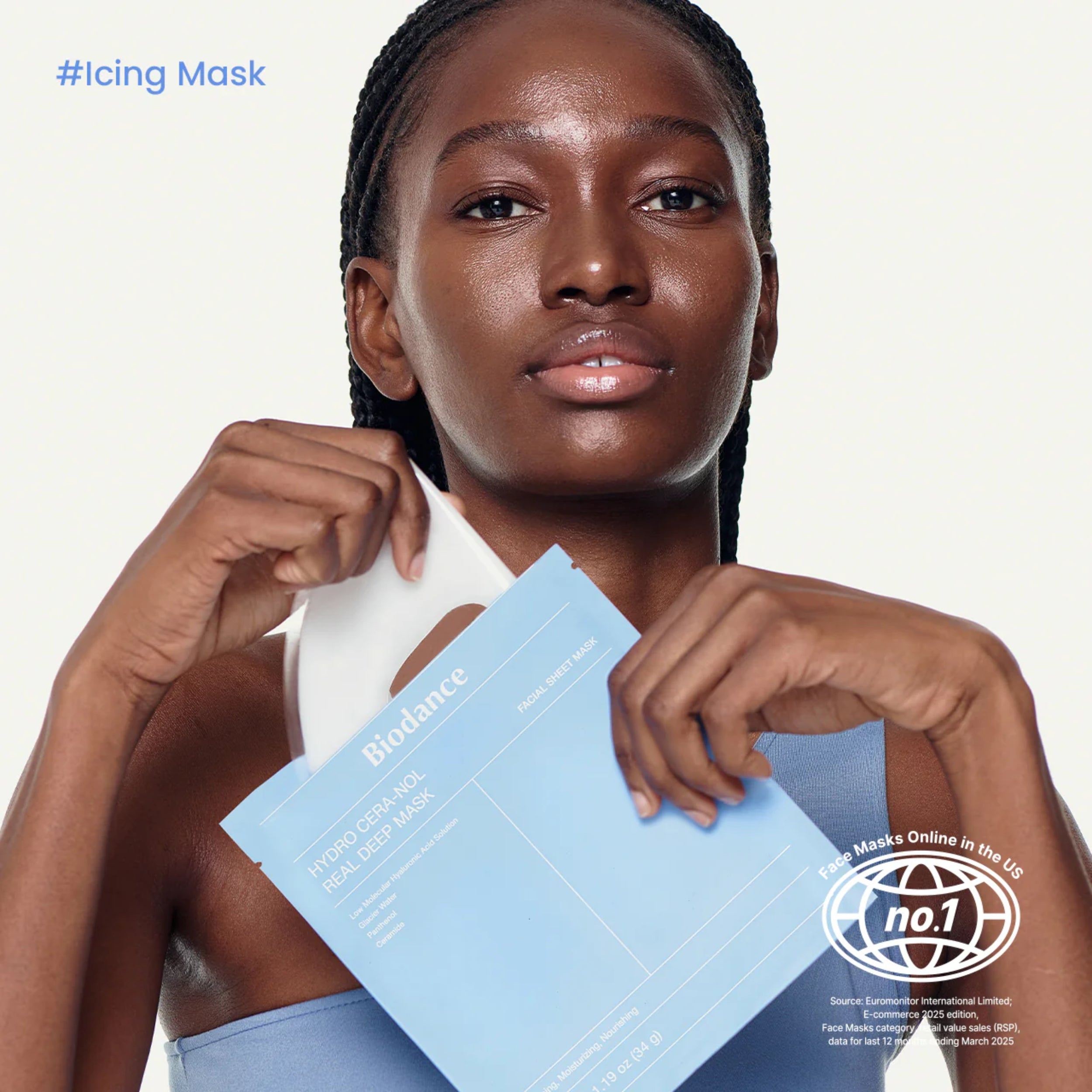 Woman holding a skincare mask package with visible branding on a white background