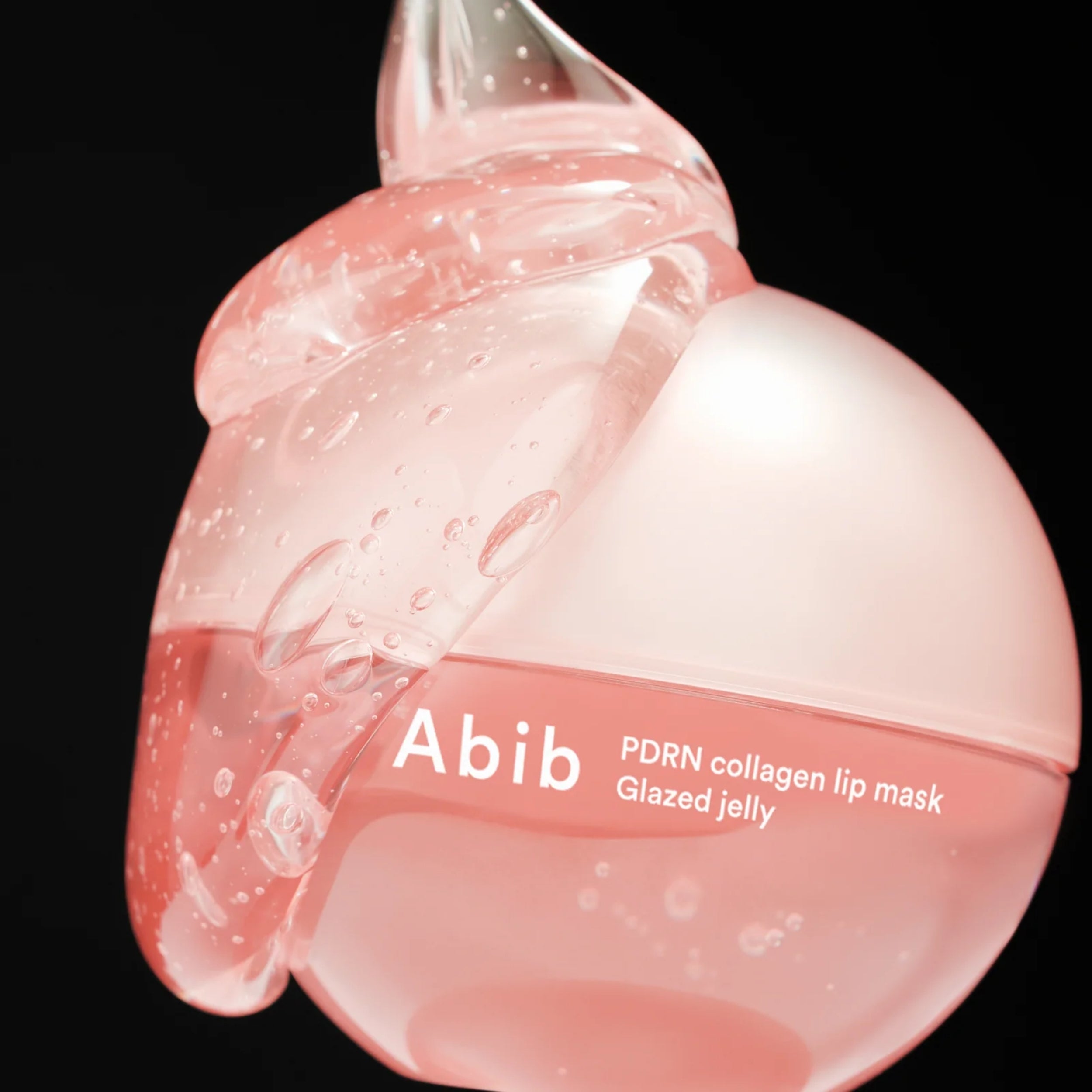 Pink lip mask with 'Abib' branding on a black background