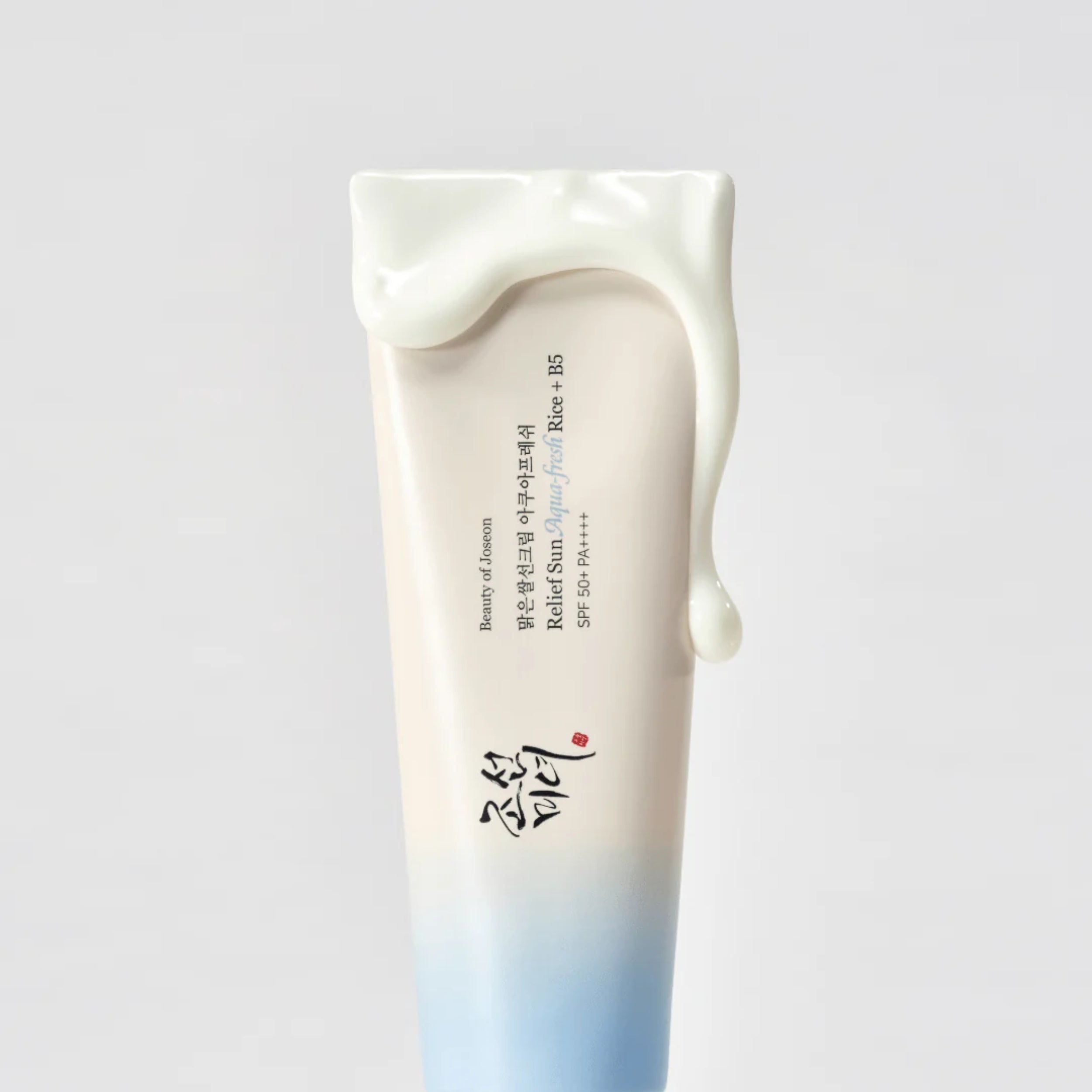 Tube of sunscreen with gradient design on a light gray background