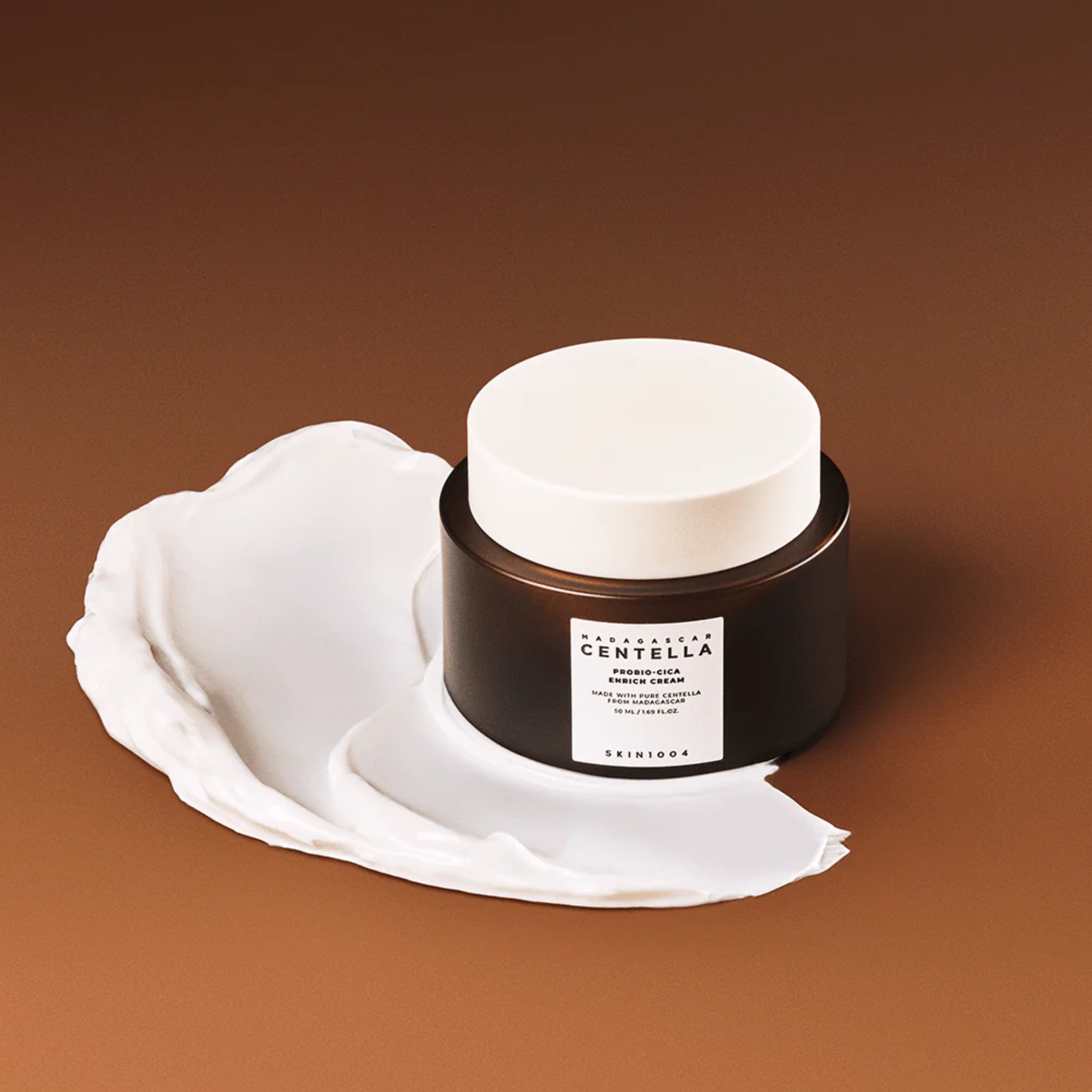 Skincare jar with white lid on a white shell against a brown background