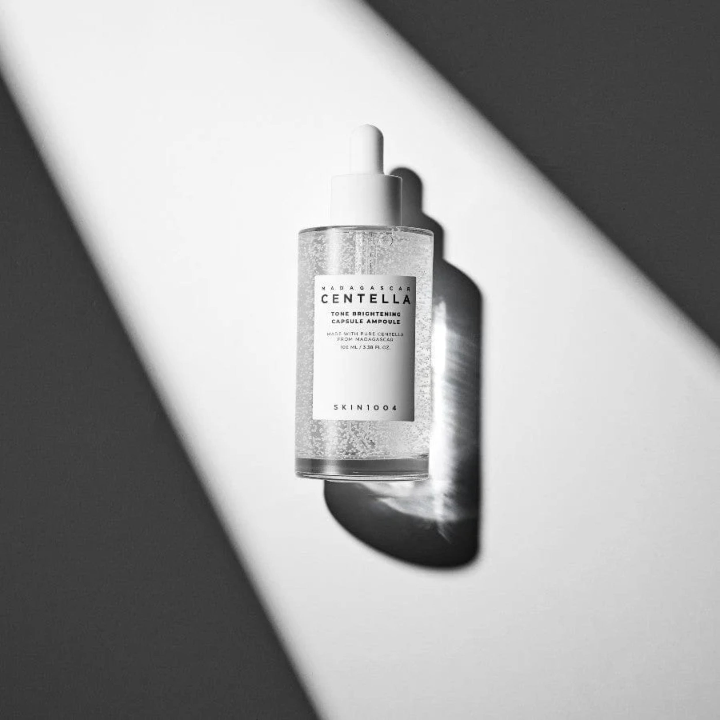 Skincare bottle with label on a gray background