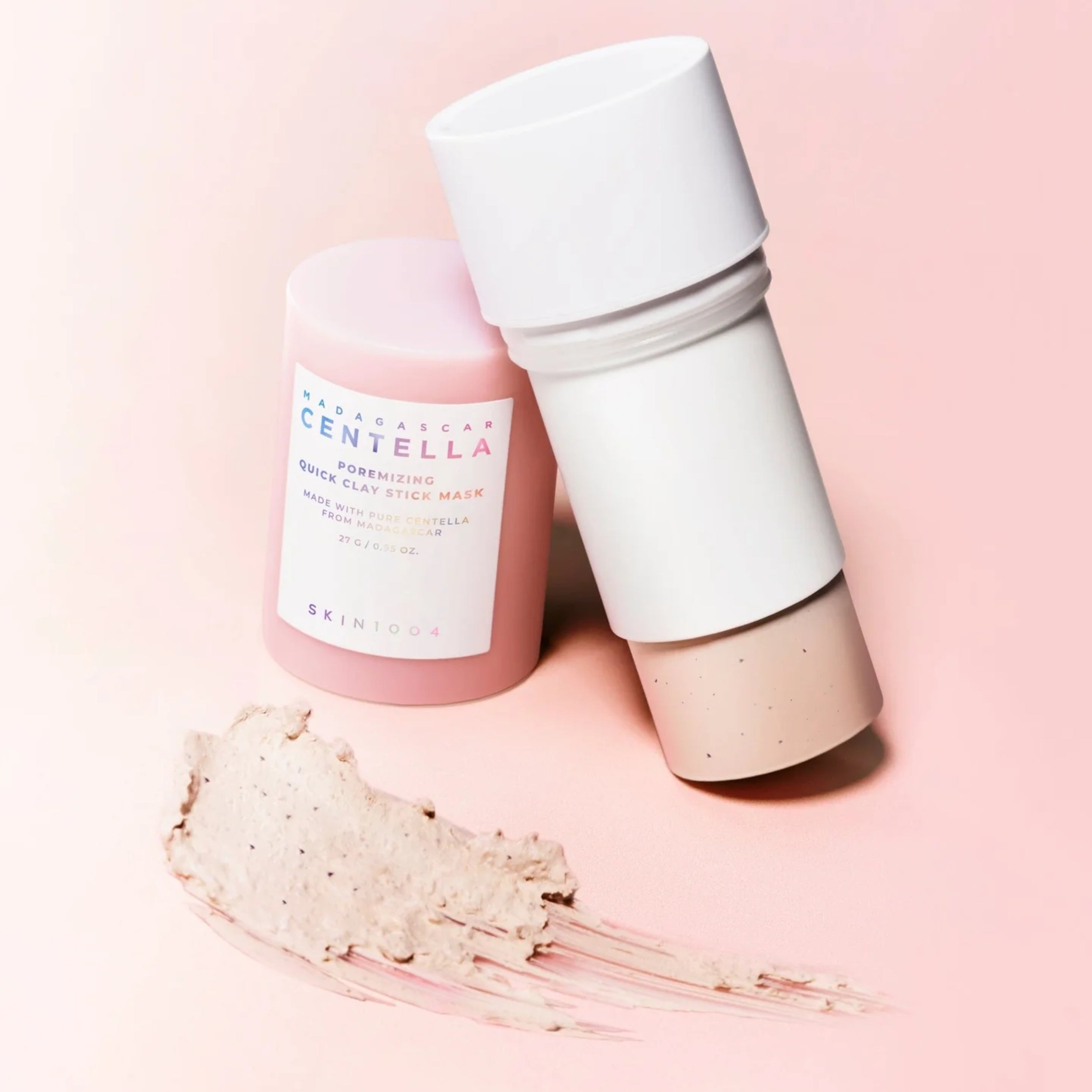 Skincare product with a white cap and pink body on a light pink background
