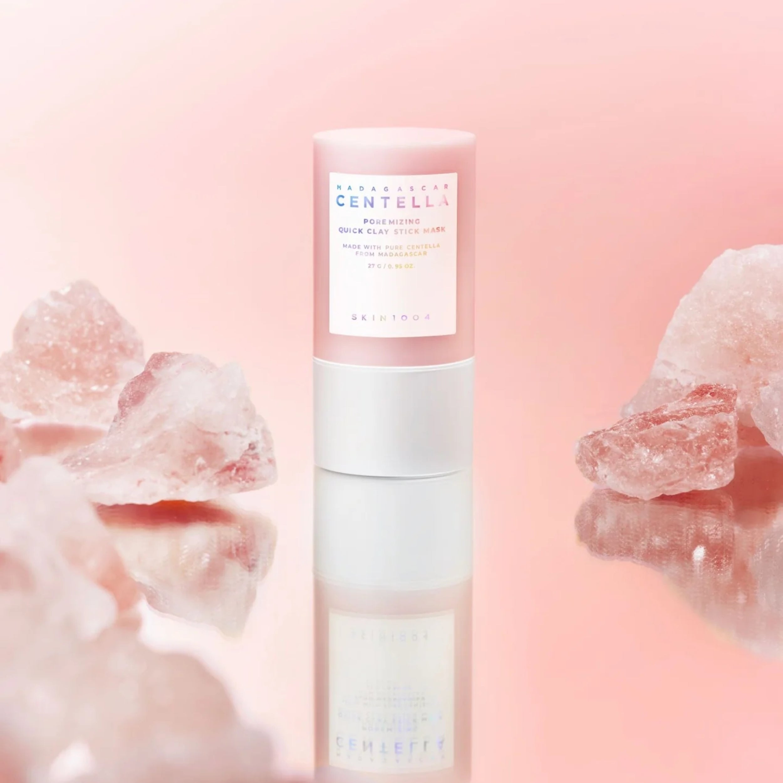 Skincare bottle with pink floral elements on a soft pink background