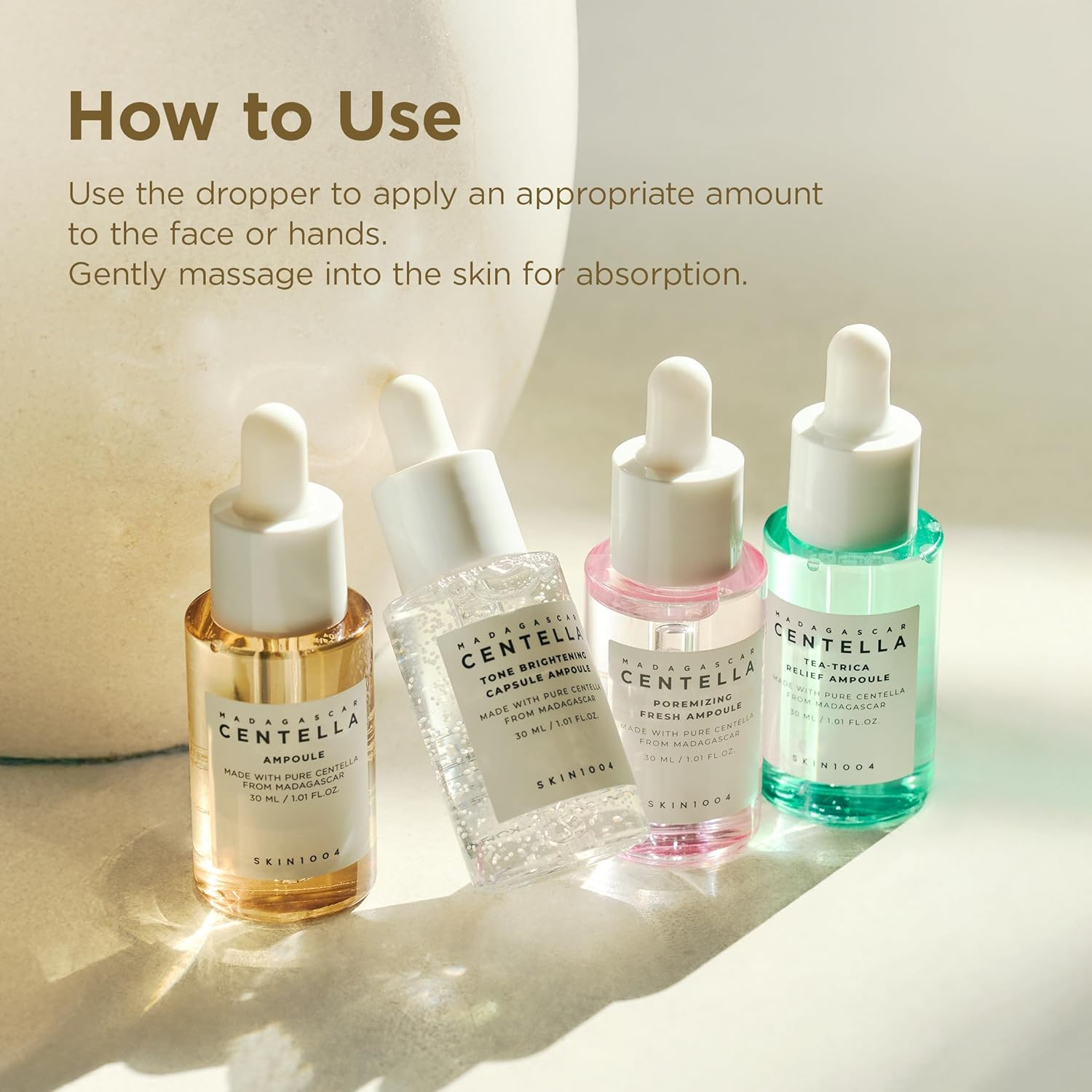 Skincare droppers with labels on a light background