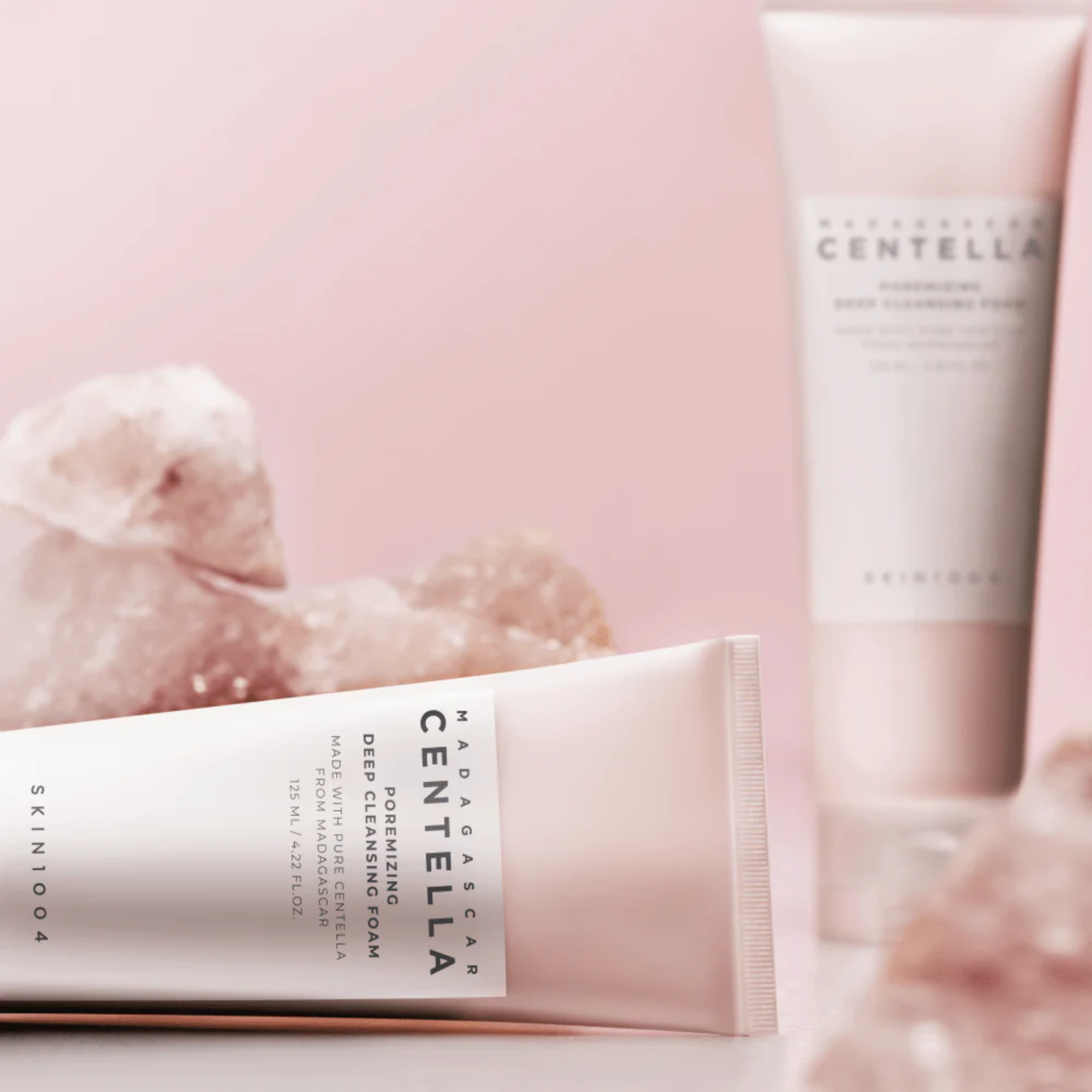 Two tubes of Skin1004 Madara Centella cleansing foam on a pink background
