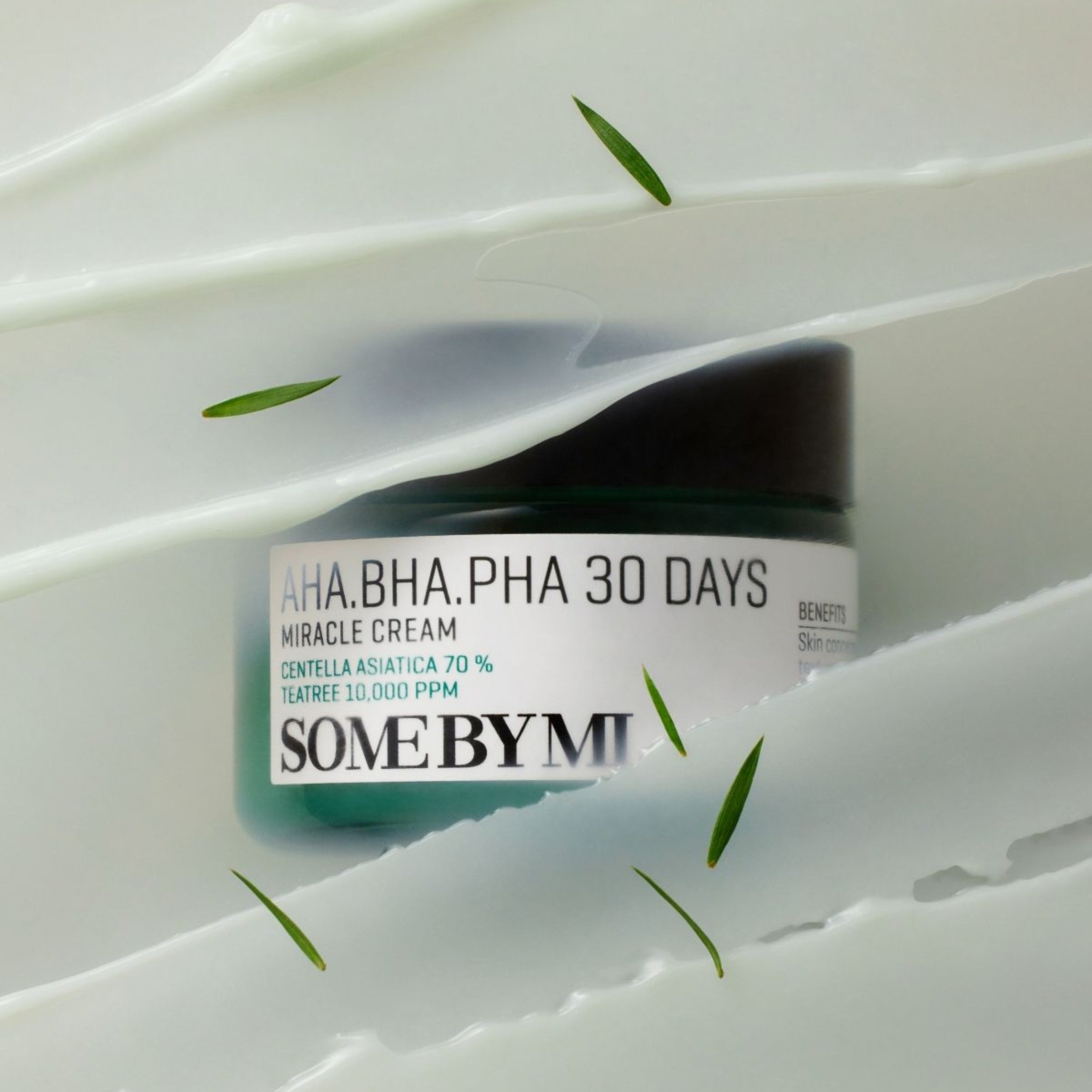 Skincare cream jar labeled 'SOME BY MI' on a white background with green leaves.