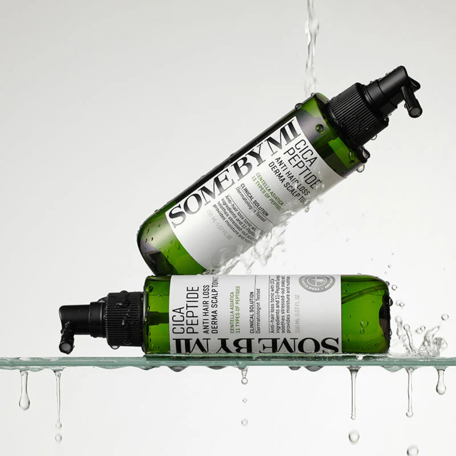 Two green skincare bottles with white labels on a gray background