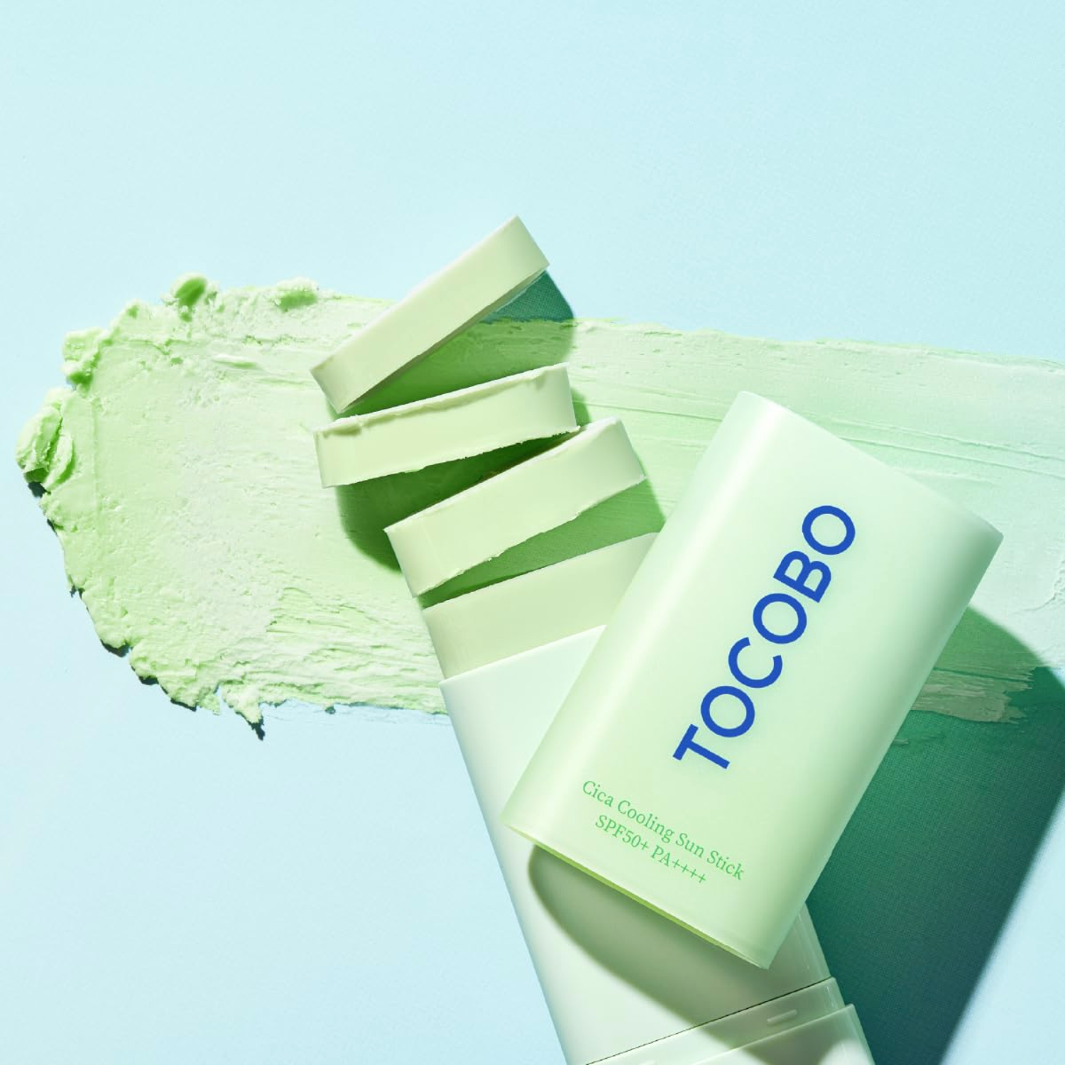 Tocobo skincare product with green cream on a light blue background