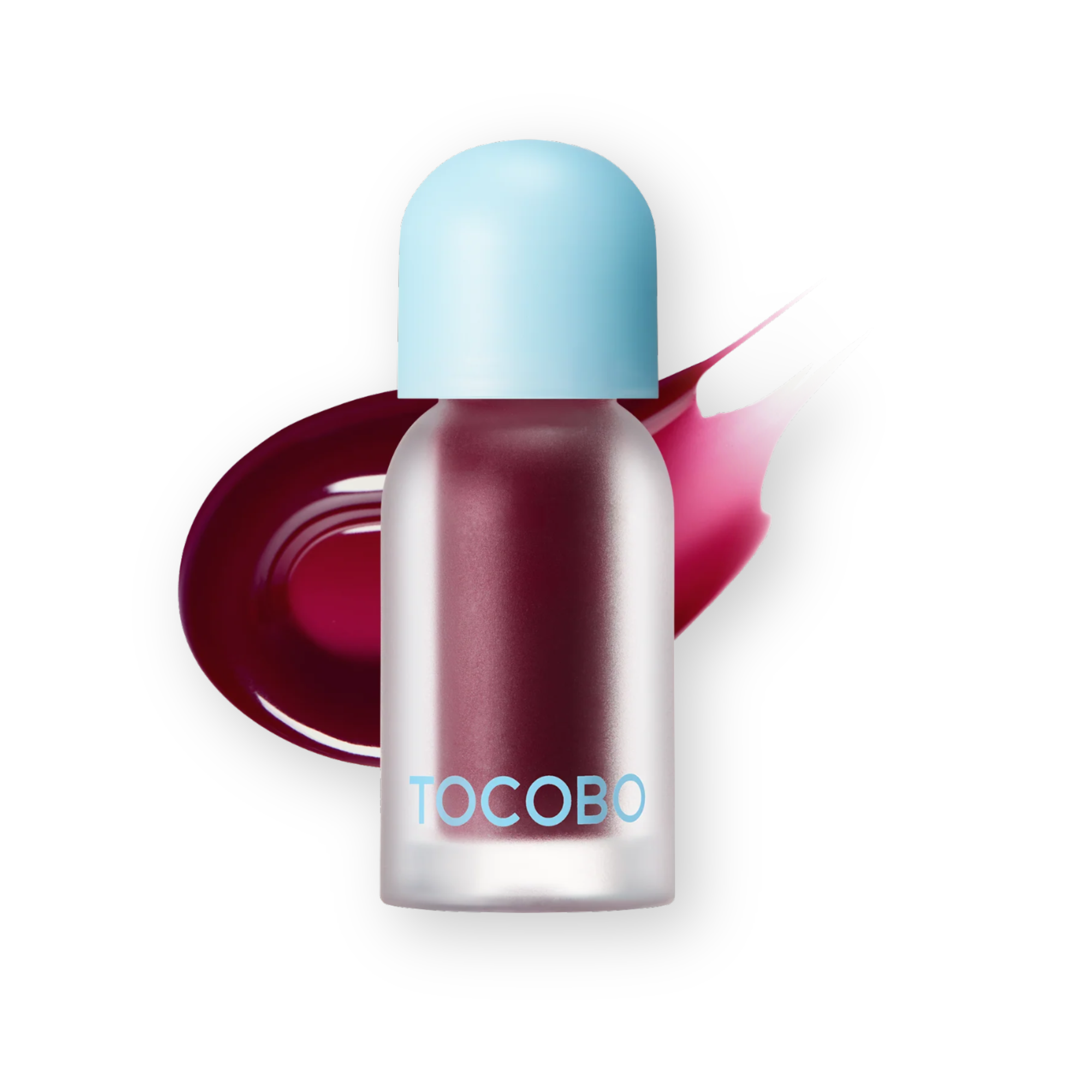 A clear cylindrical bottle with a light blue cap, filled with deep berry-red cosmetic product, shown on a white background with a glossy swipe of the same shade behind it. The brand name TOCOBO is printed in light blue on the bottle.